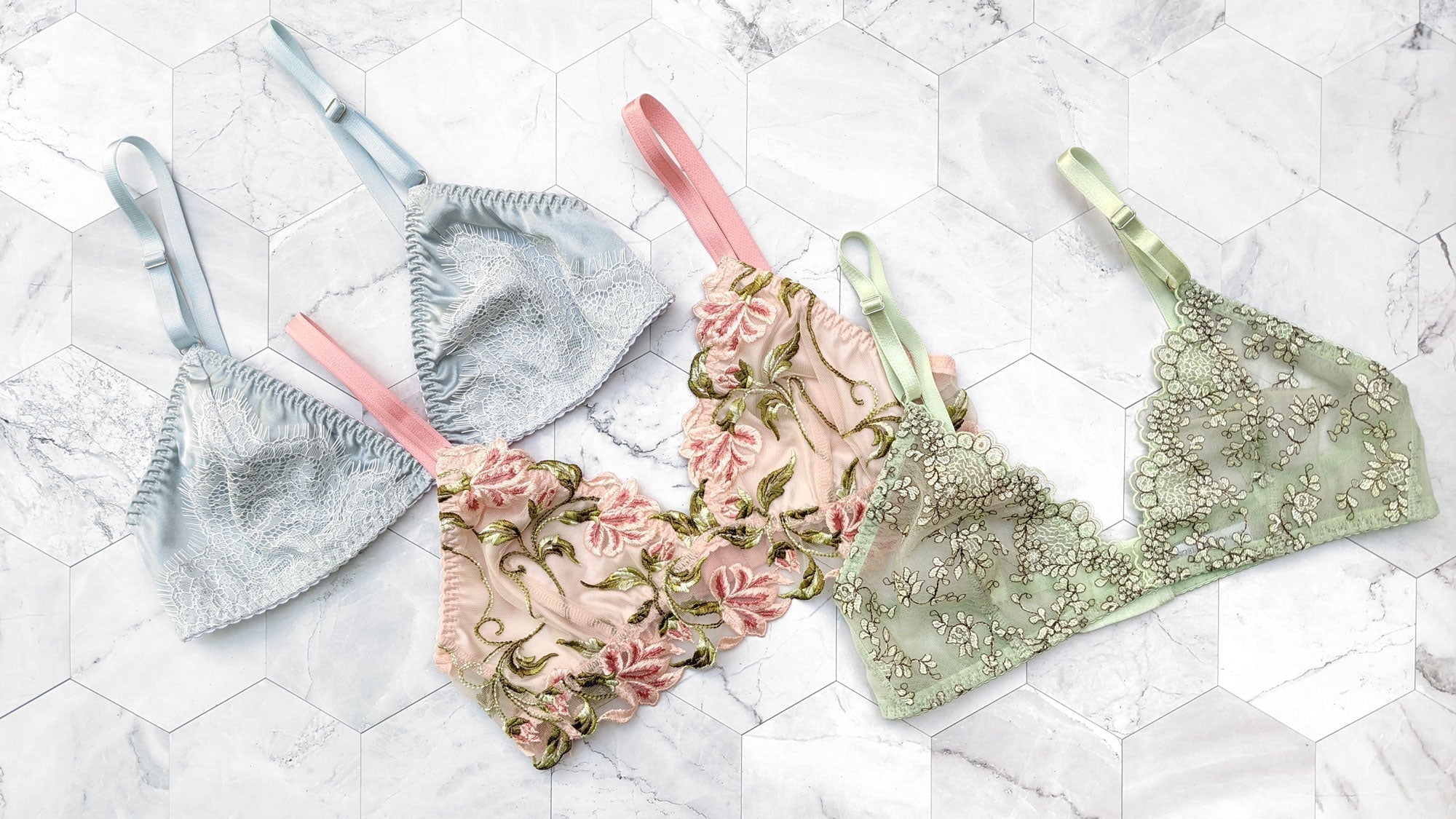 Blue, pink, and mint green bralettes with lace and embroidered trims