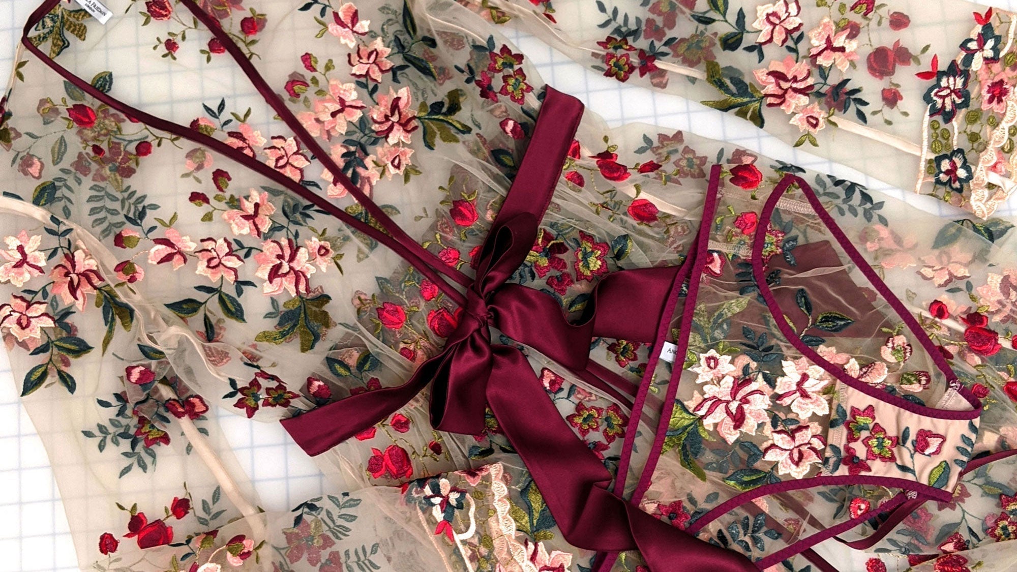 A luxury, embroidered robe and floral, red panties by lingerie designer Angela Friedman