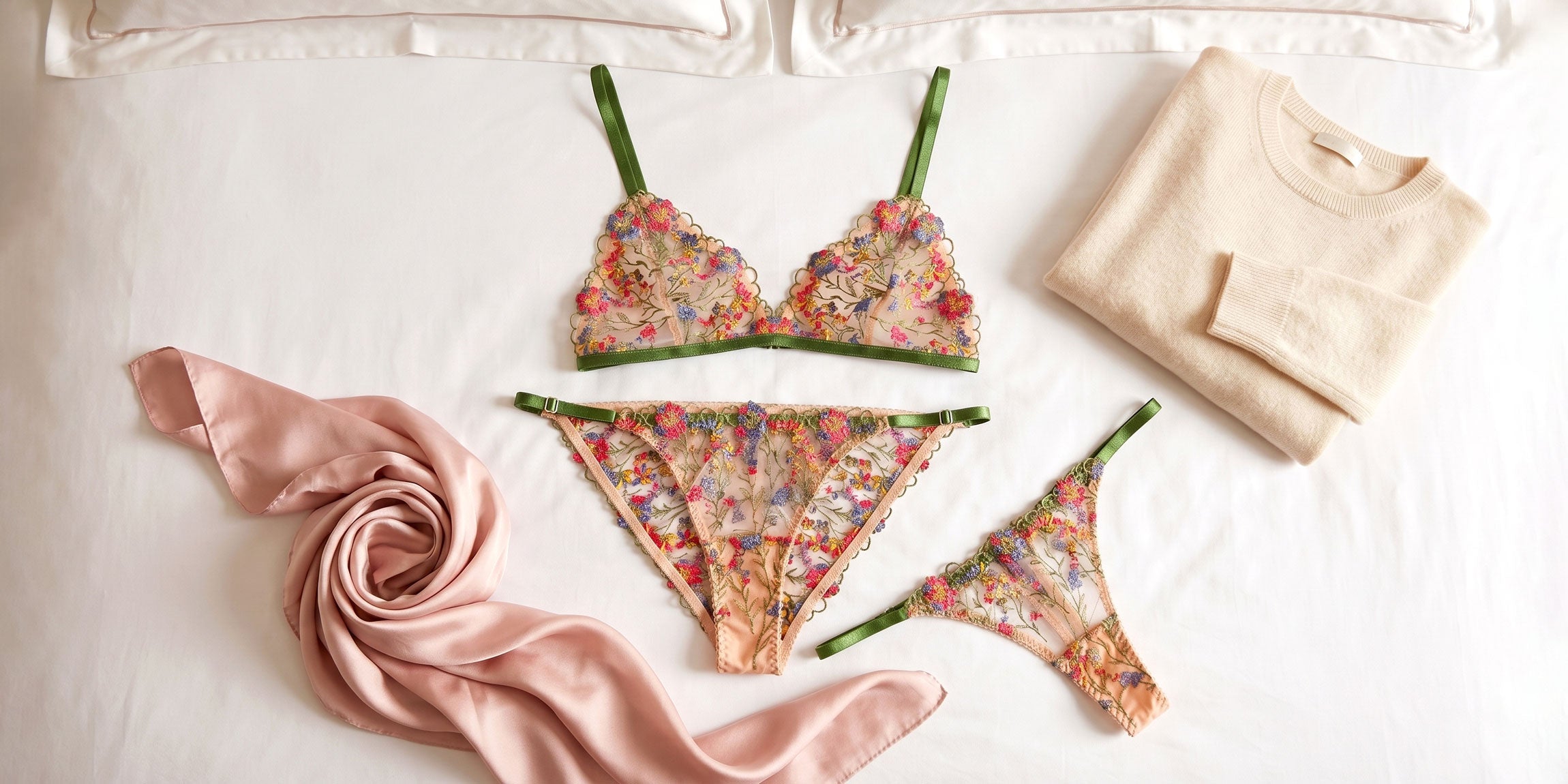 Embroidered lingerie set in nude, red, blue, and green with a cashmere sweater