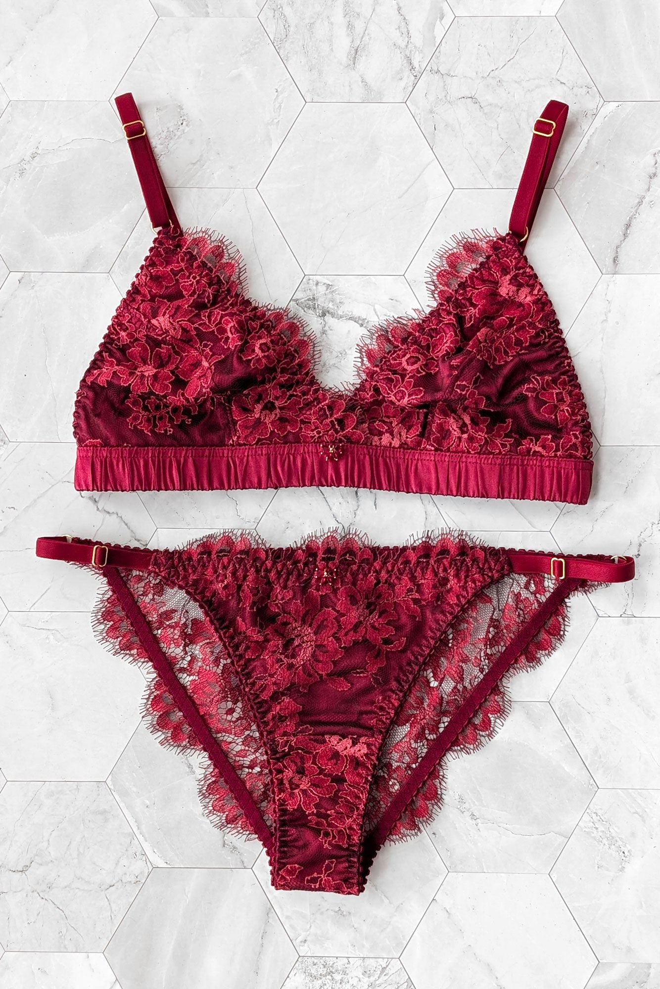 Silk and lace bra and panties set in deep red and burgundy colors with a jewelry bow charm at the front