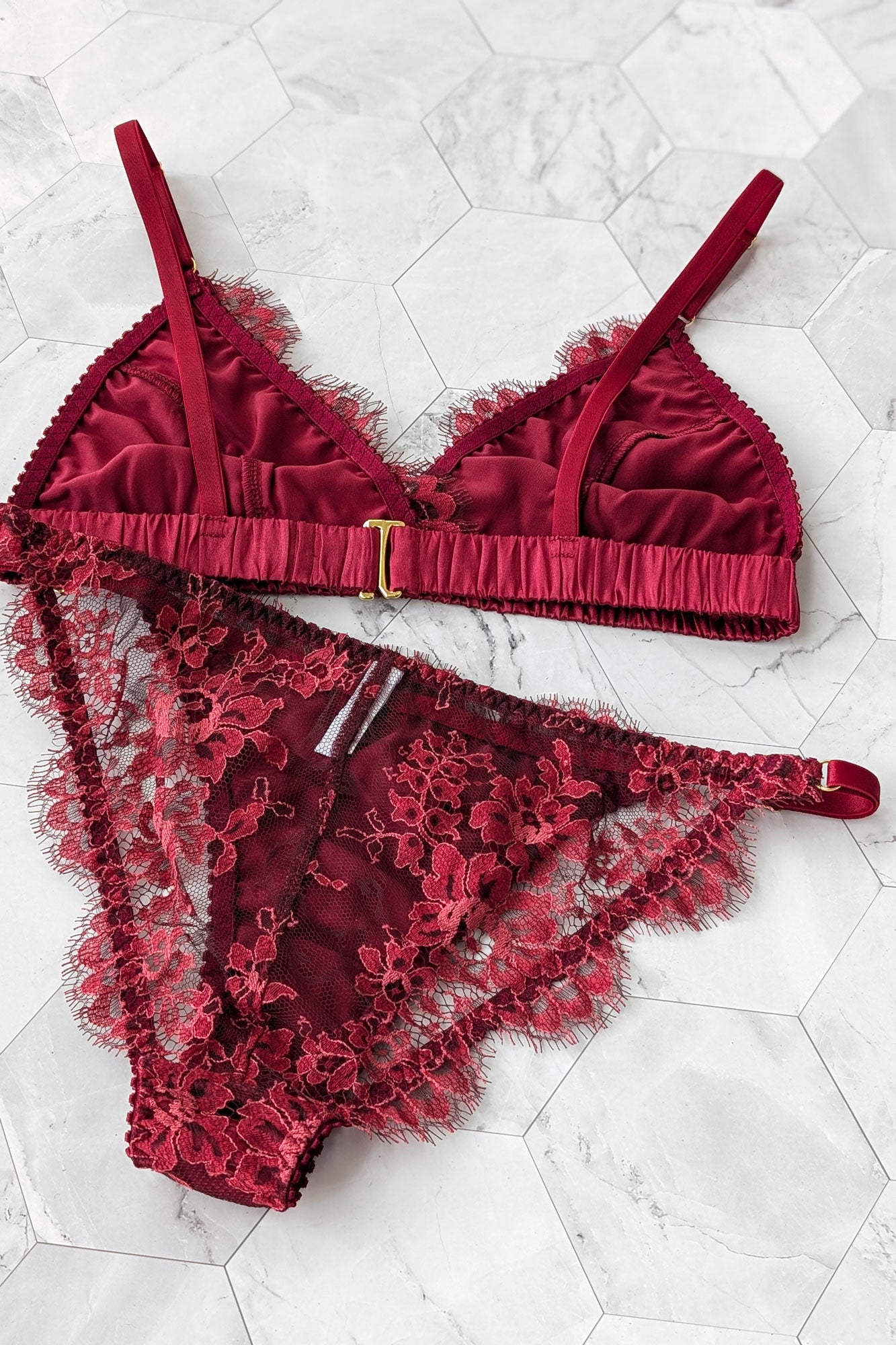 Back view of a designer lingerie set in imported red French lace with scalloped lace edges and eyelash trims