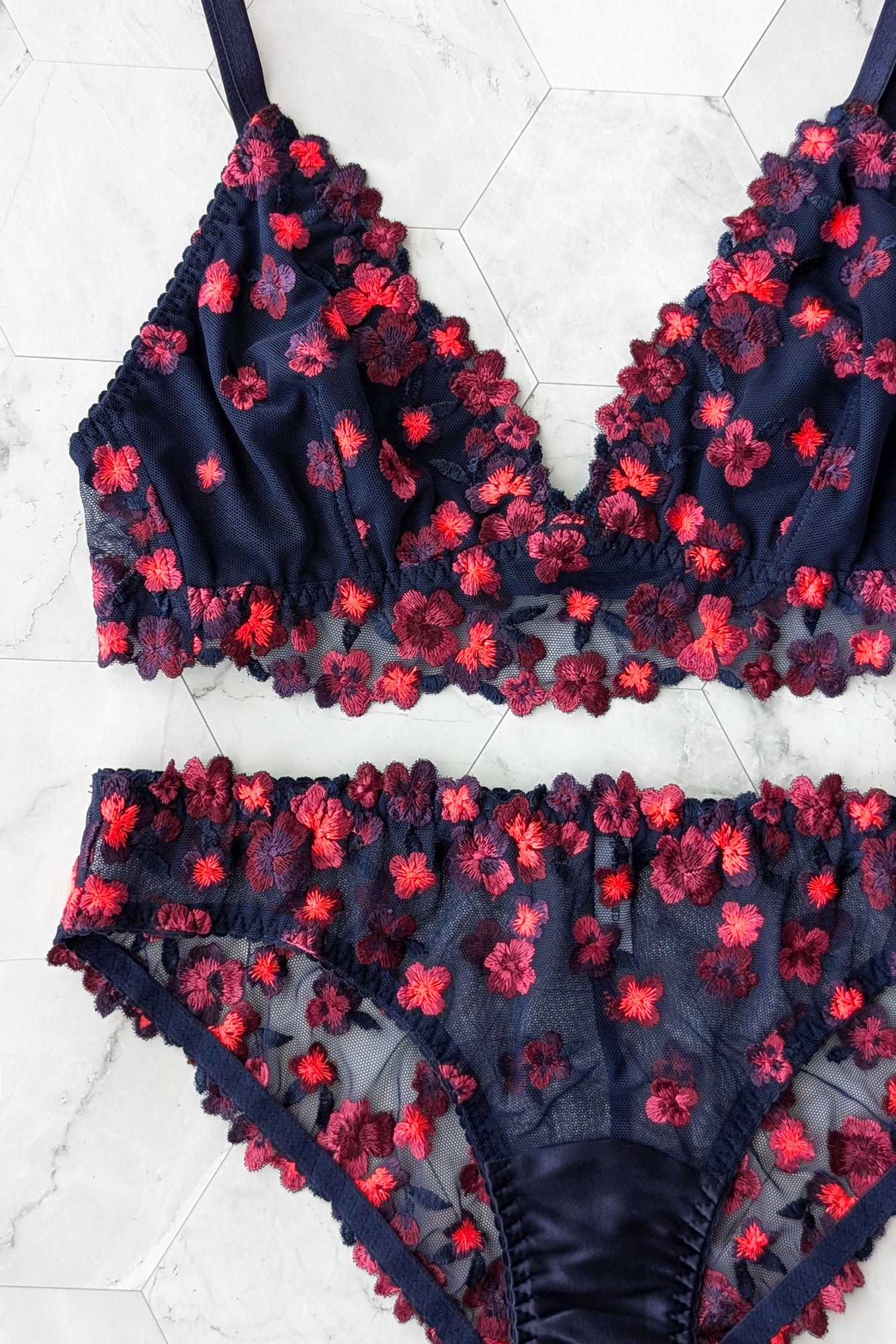 Glowing neon lingerie set with a navy blue wirefree bralette and stretch mesh and silk knickers