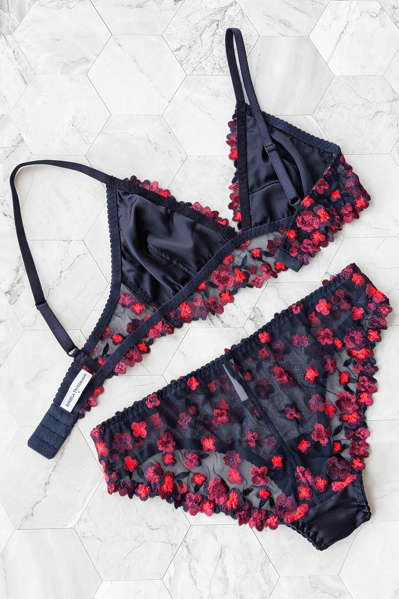 Silk bralette with fluorescent colored embroidery and flower trims in navy blue and red