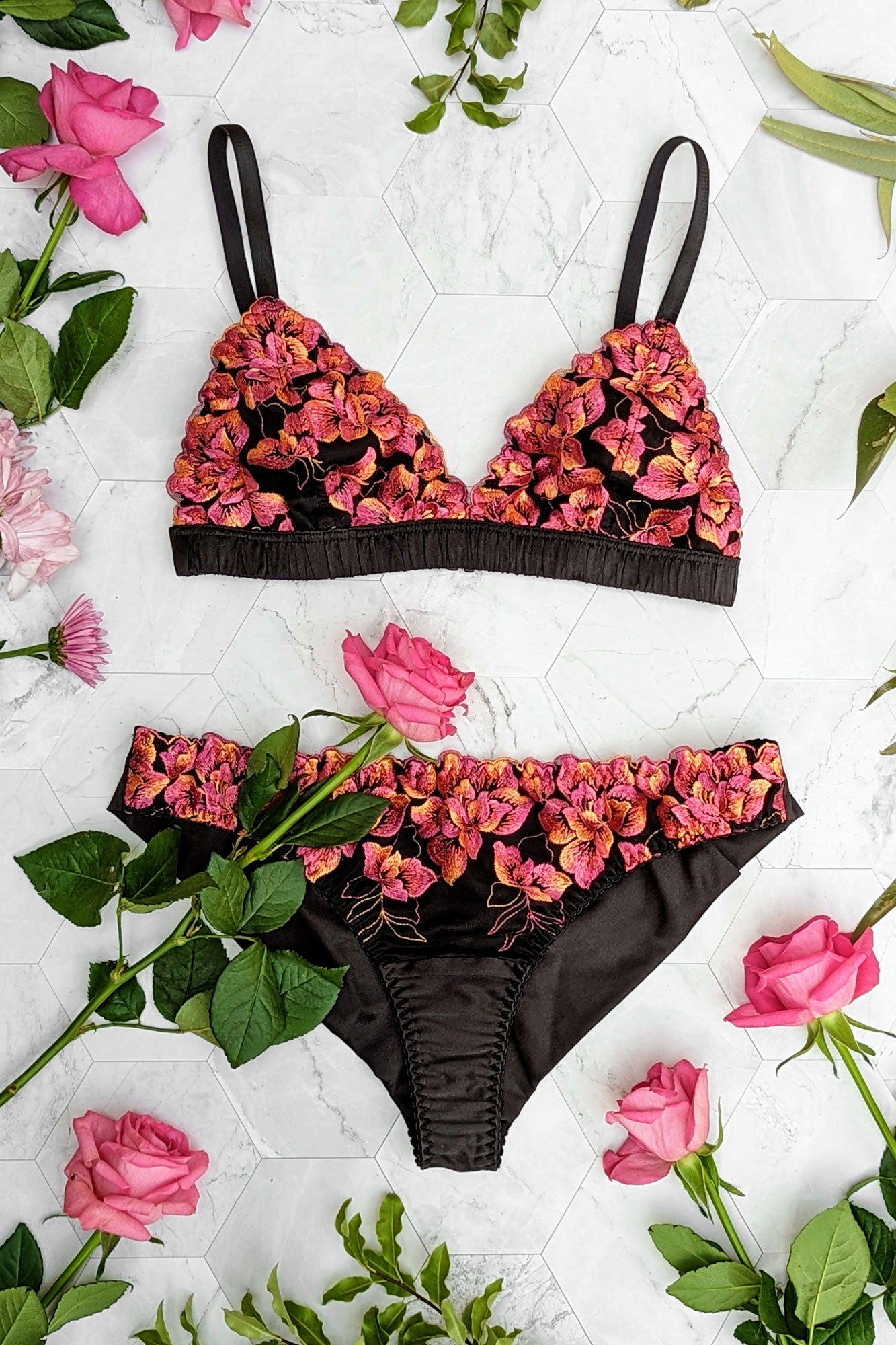 Magenta and black lingerie set with a silk bralette and floral knickers