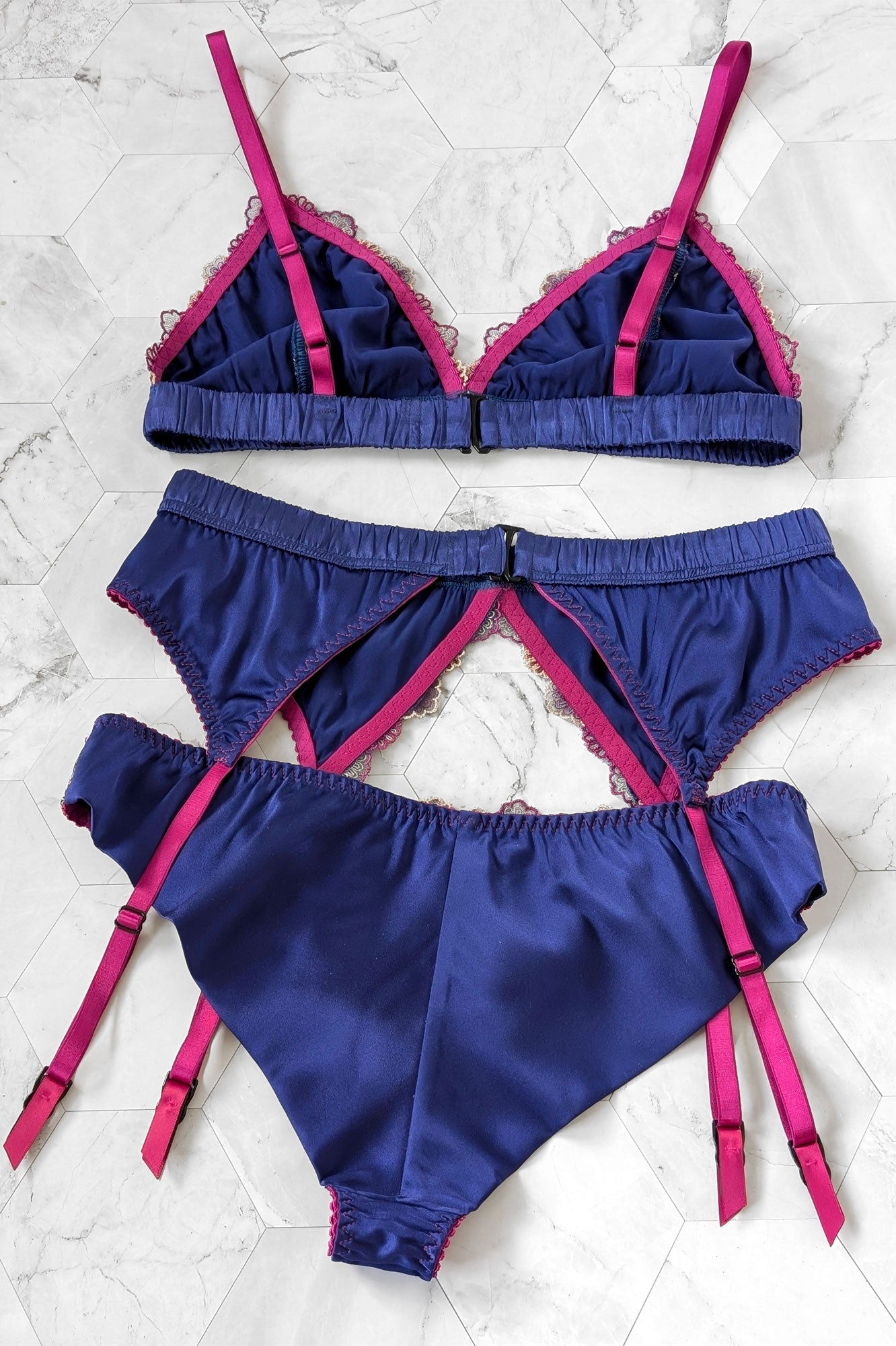 Silk lingerie set with blue cheeky panties, a satin garter belt, and a silk wire-free bralette for vintage aesthetics