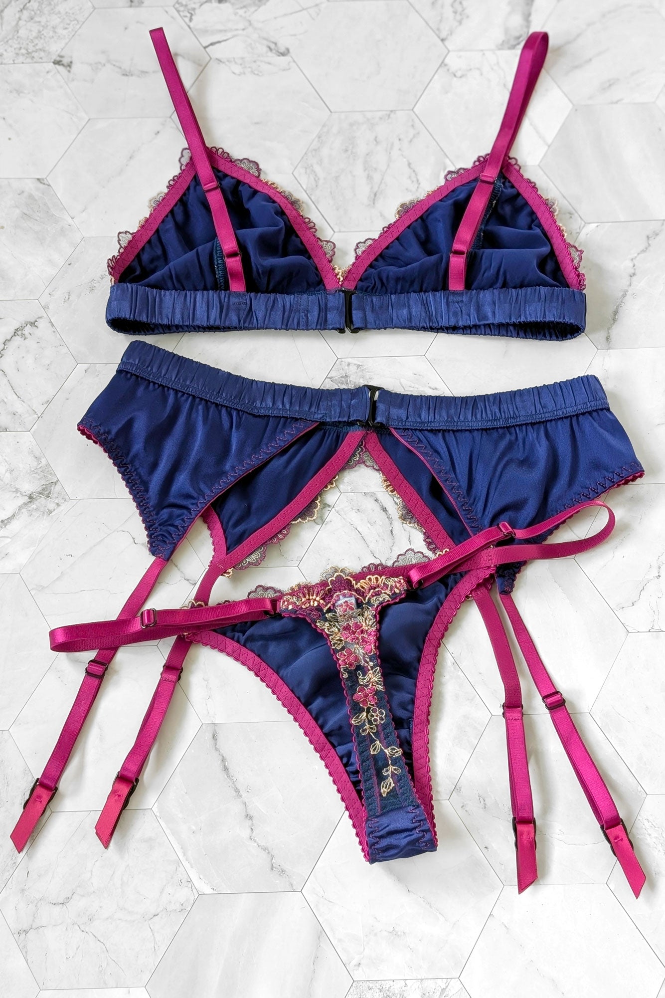 Real silk lingerie set including a blue satin bralet, vintage garter belt, and strappy thong