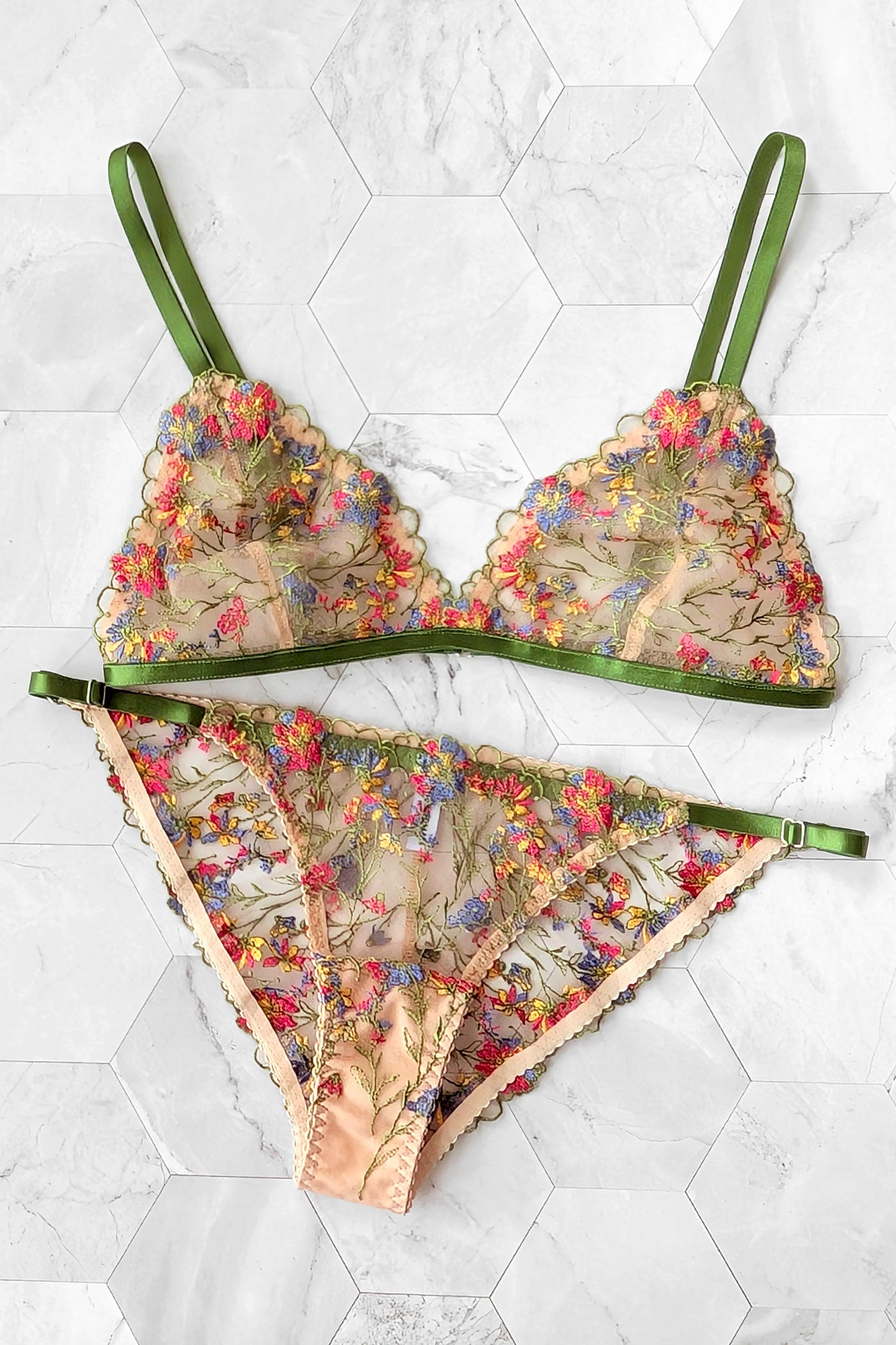 Floral lingerie set in sheer tulle with multicolored embroidered flowers and foliage, trimmed with bright green elastic straps