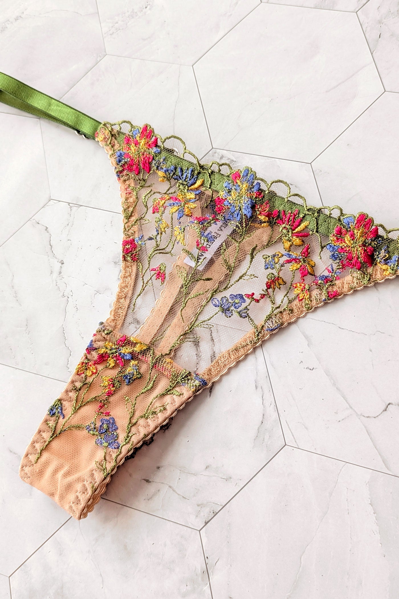 Embroidered Meadow Thong with red and blue flowers and green elastic adjustable waist straps