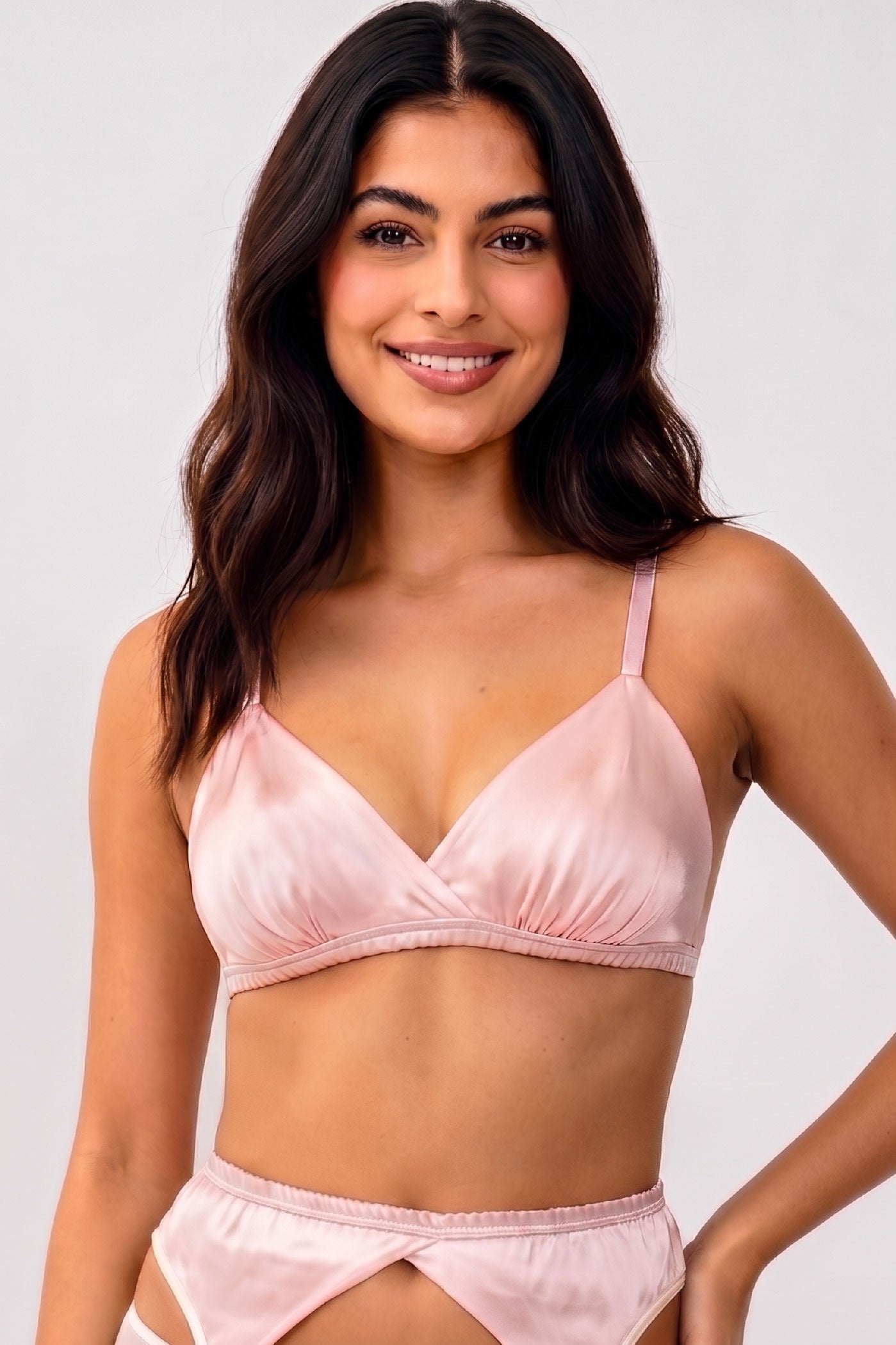 Pink silk bralette cut in a triangle wireless style with light pink elastic straps