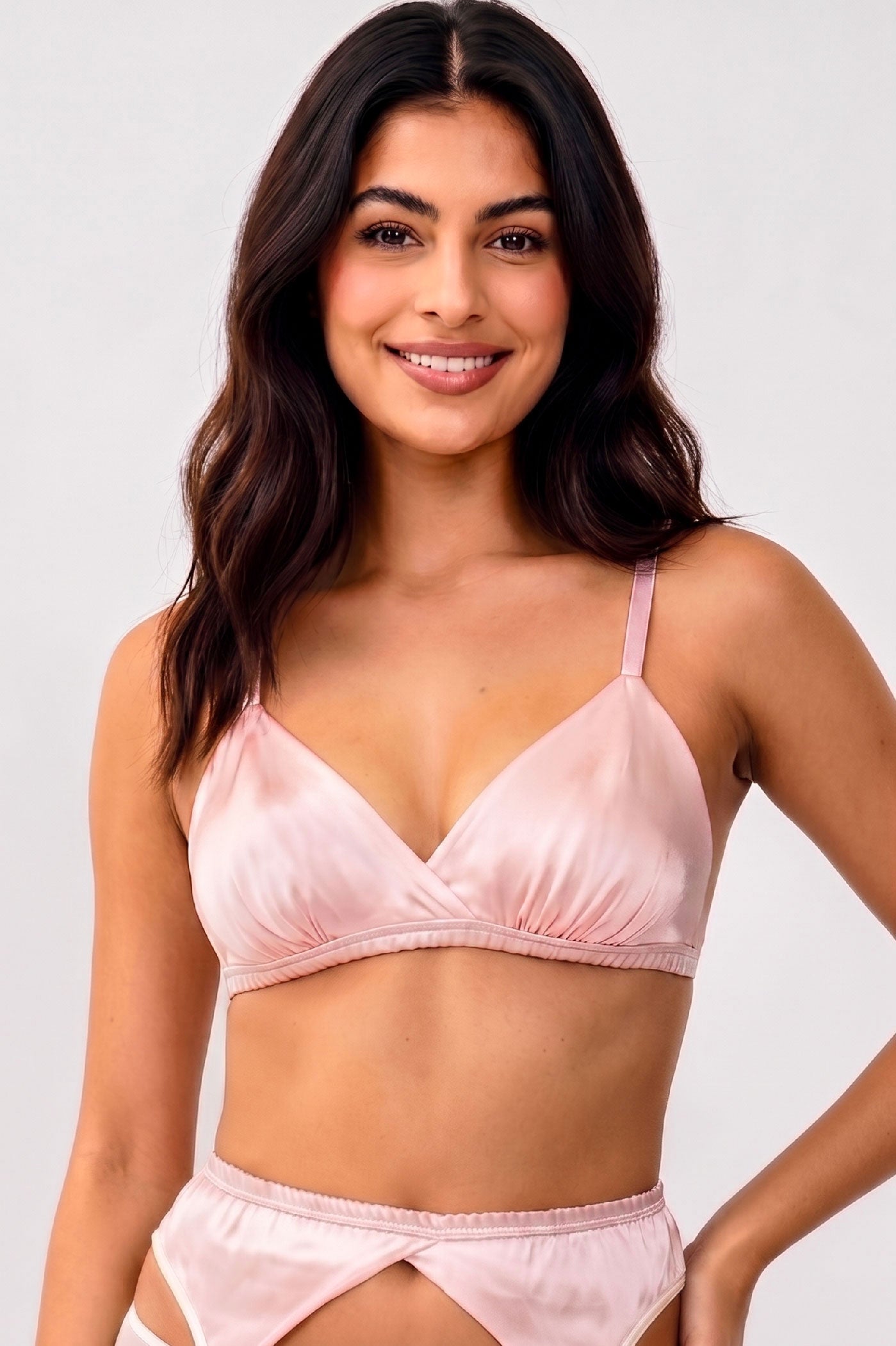 Pink silk bralette cut in a triangle wireless style with light pink elastic straps