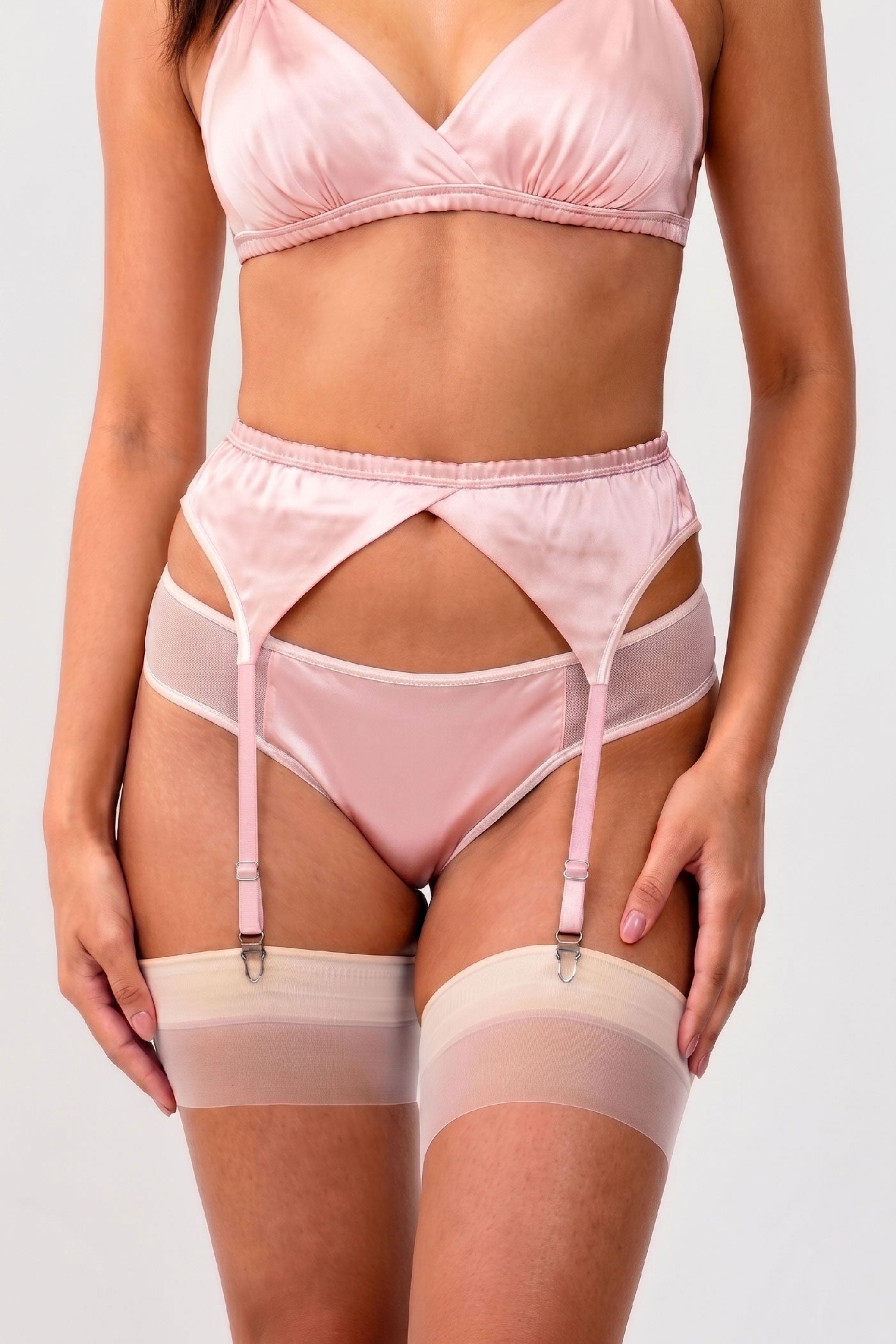 Pink silk knickers with white mesh trim and a strappy garter belt and stockings