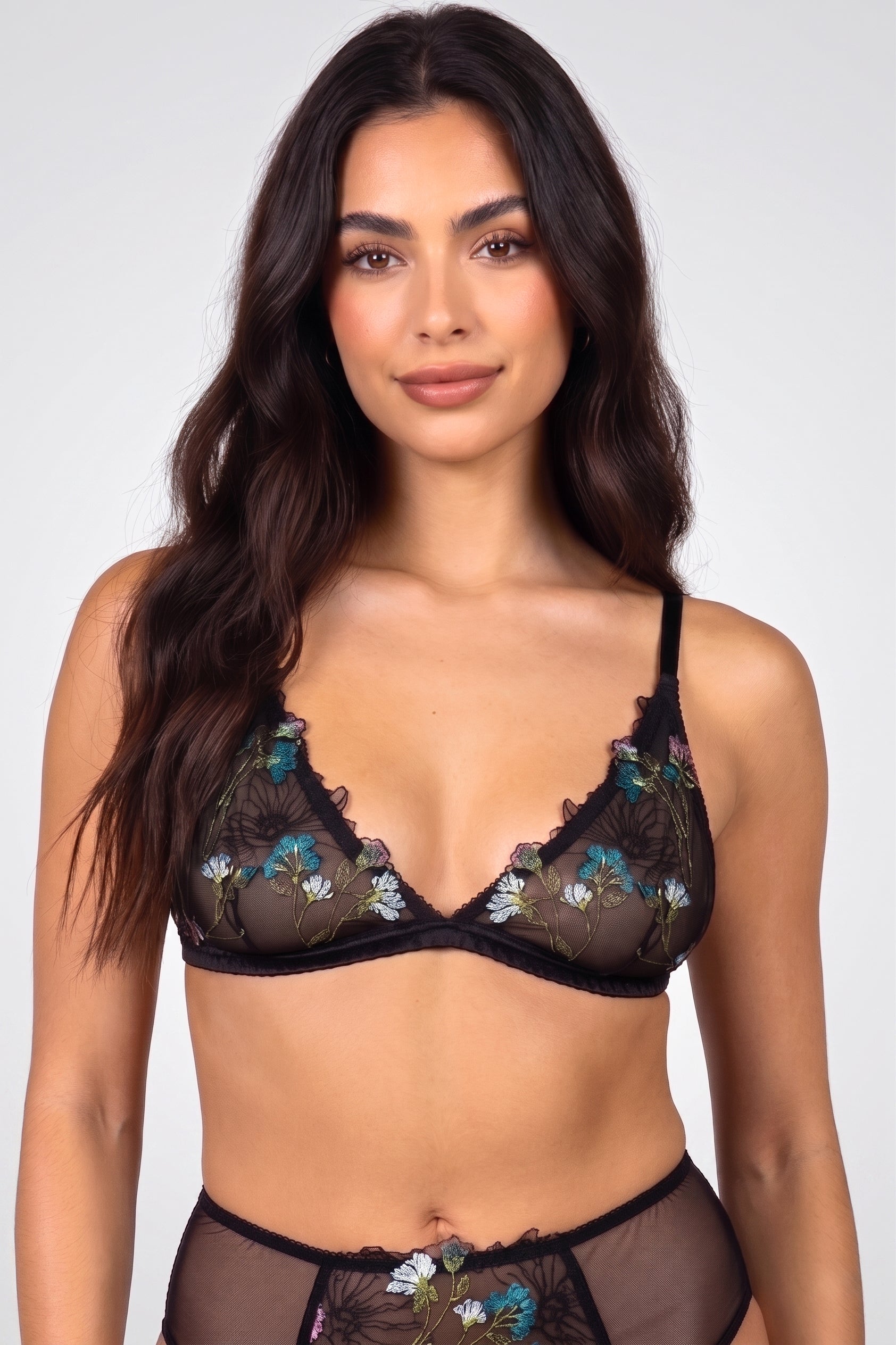 Seraphina bralette in black mesh with turquoise, pink, green, and white flower embroidery over the cups and a silk satin band