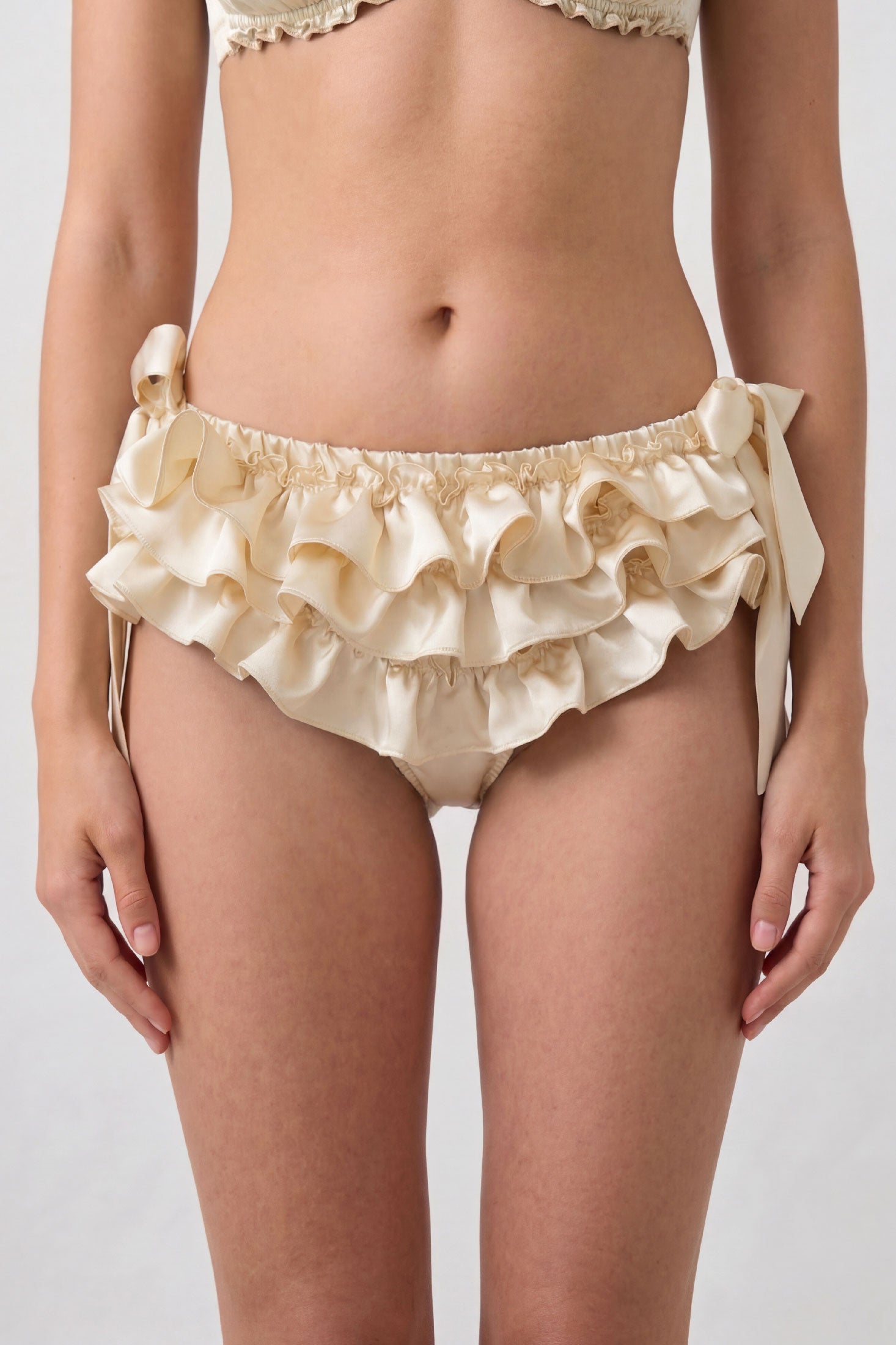 Cream silk ruffled panties with side tie bows and 3 ruffles across the front