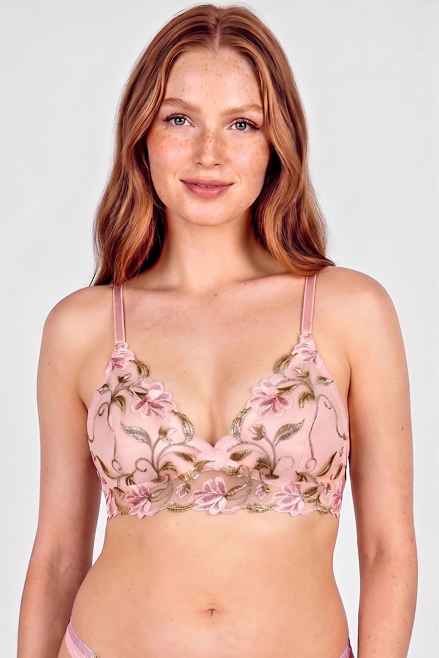 Pink and green embroidered bra with flower and vine designs and pink elastic straps