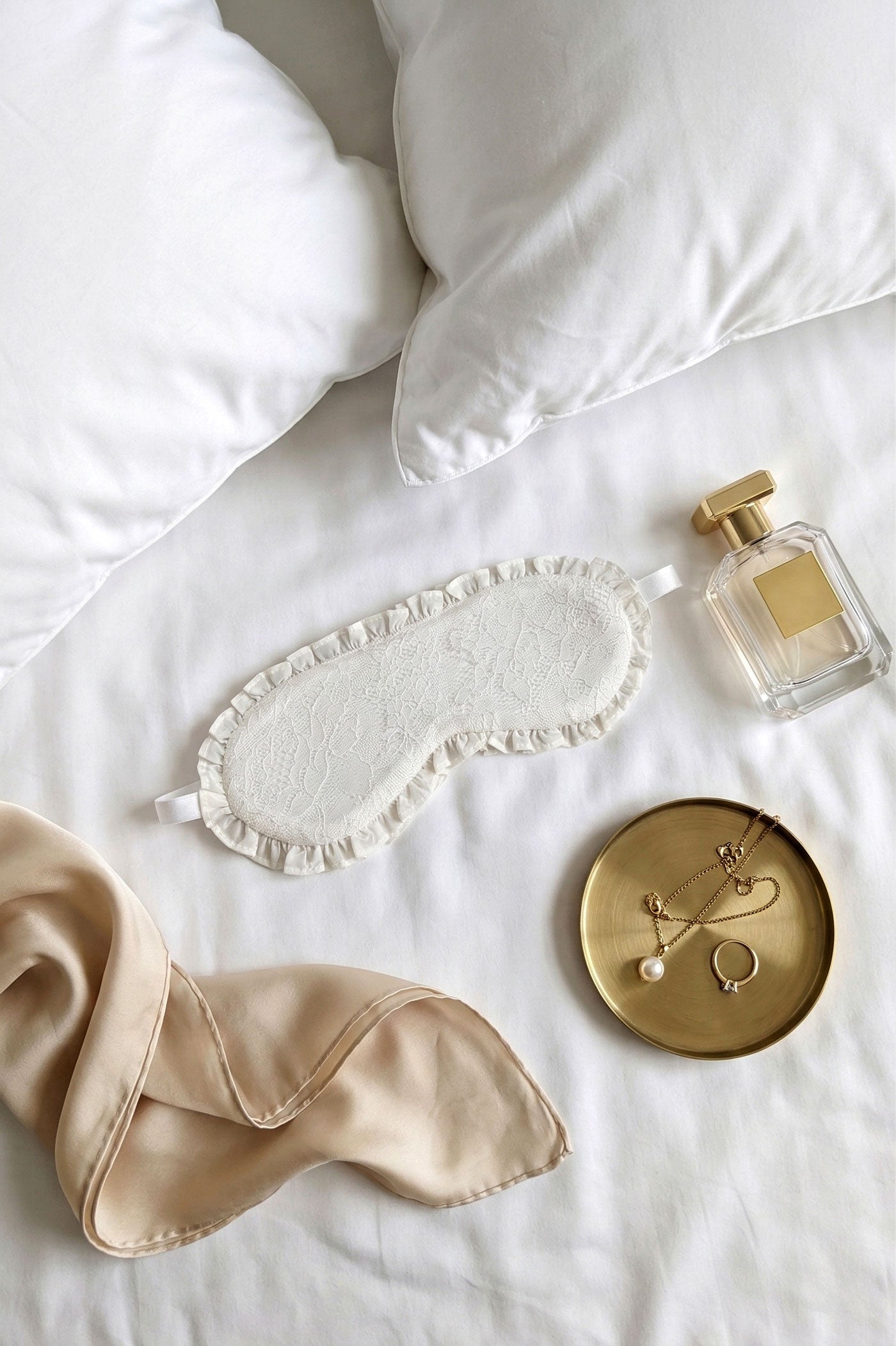 Silk sleep mask in white lace with gold jewelry, perfect for brides and wedding gifts