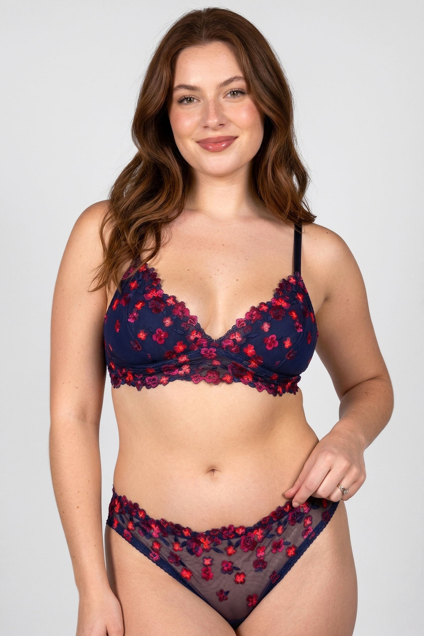 Woman wearing a navy blue and red floral lingerie set with silk linings