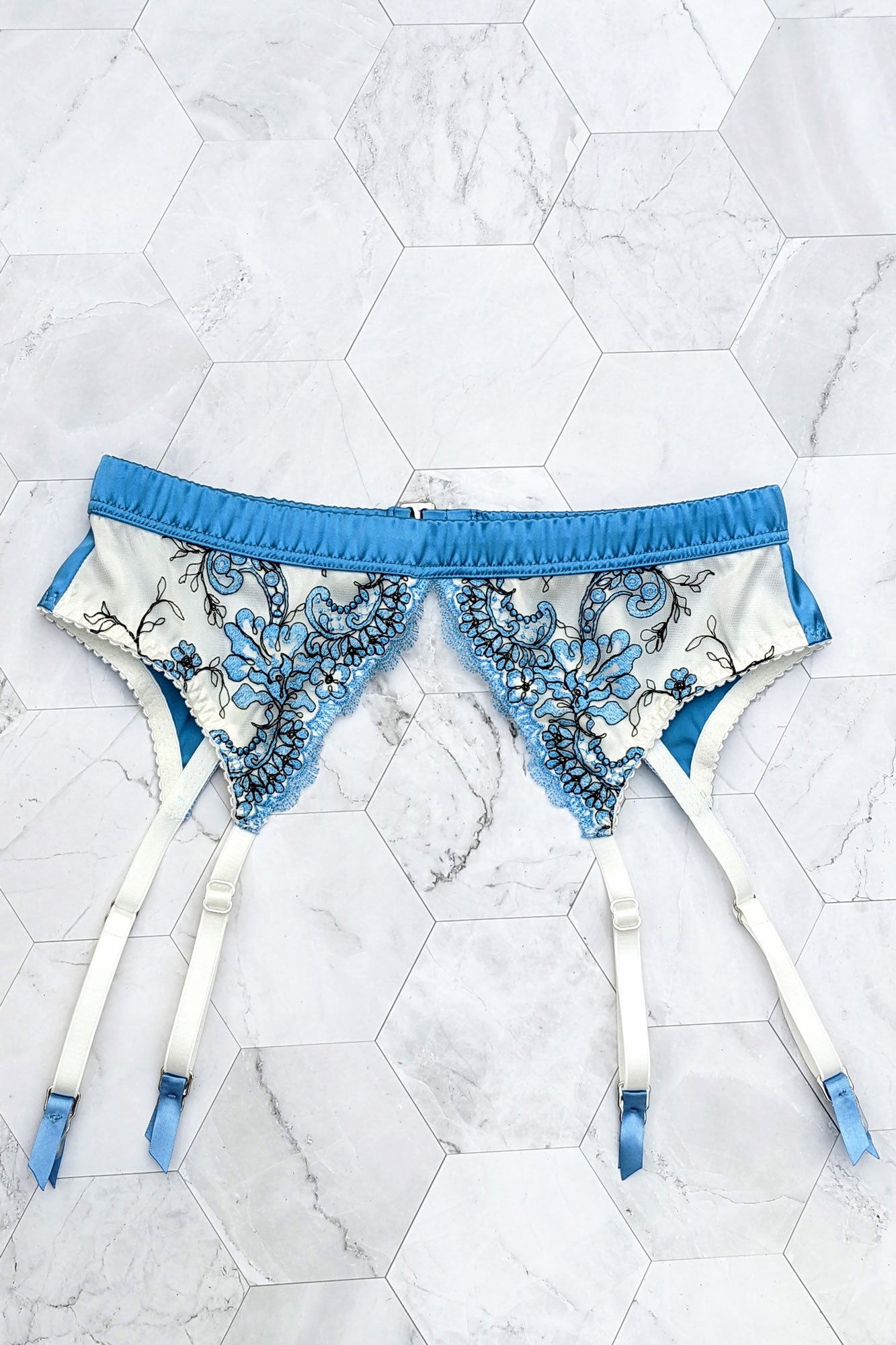 Blue silk suspender belt with white embroidery and straps