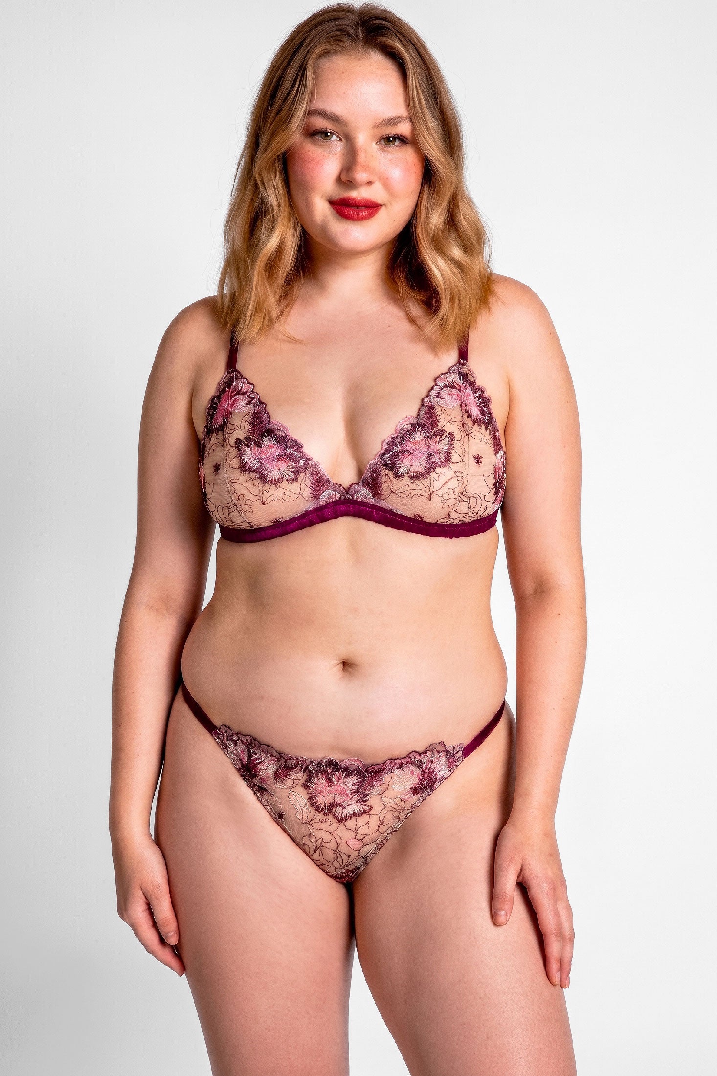 Luxury lingerie set in wine red silk with floral embroidered bra cup and a g-string thong with adjustable straps