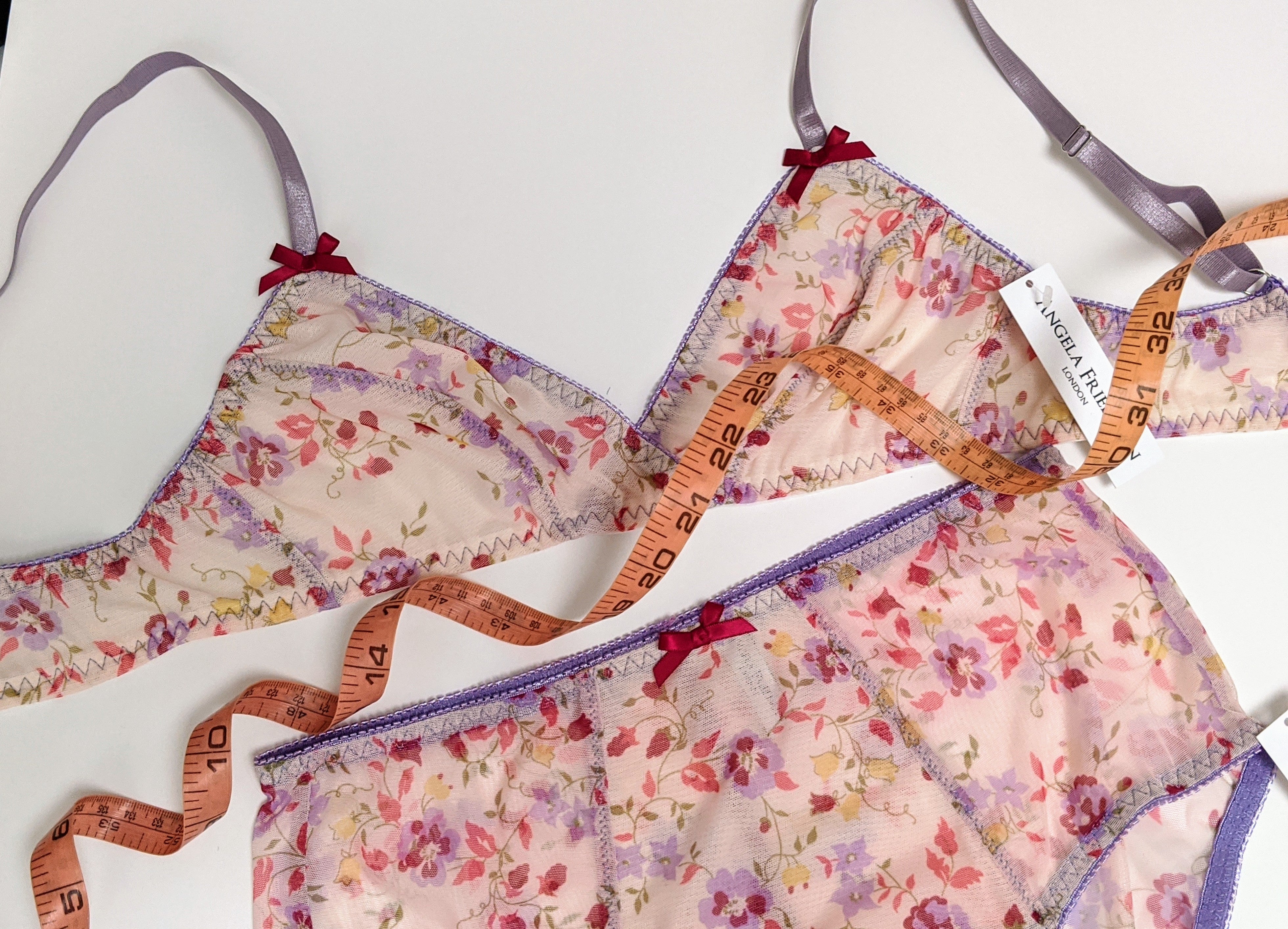 Designer underwear in pink floral mesh with purple elastic trim and tape measure