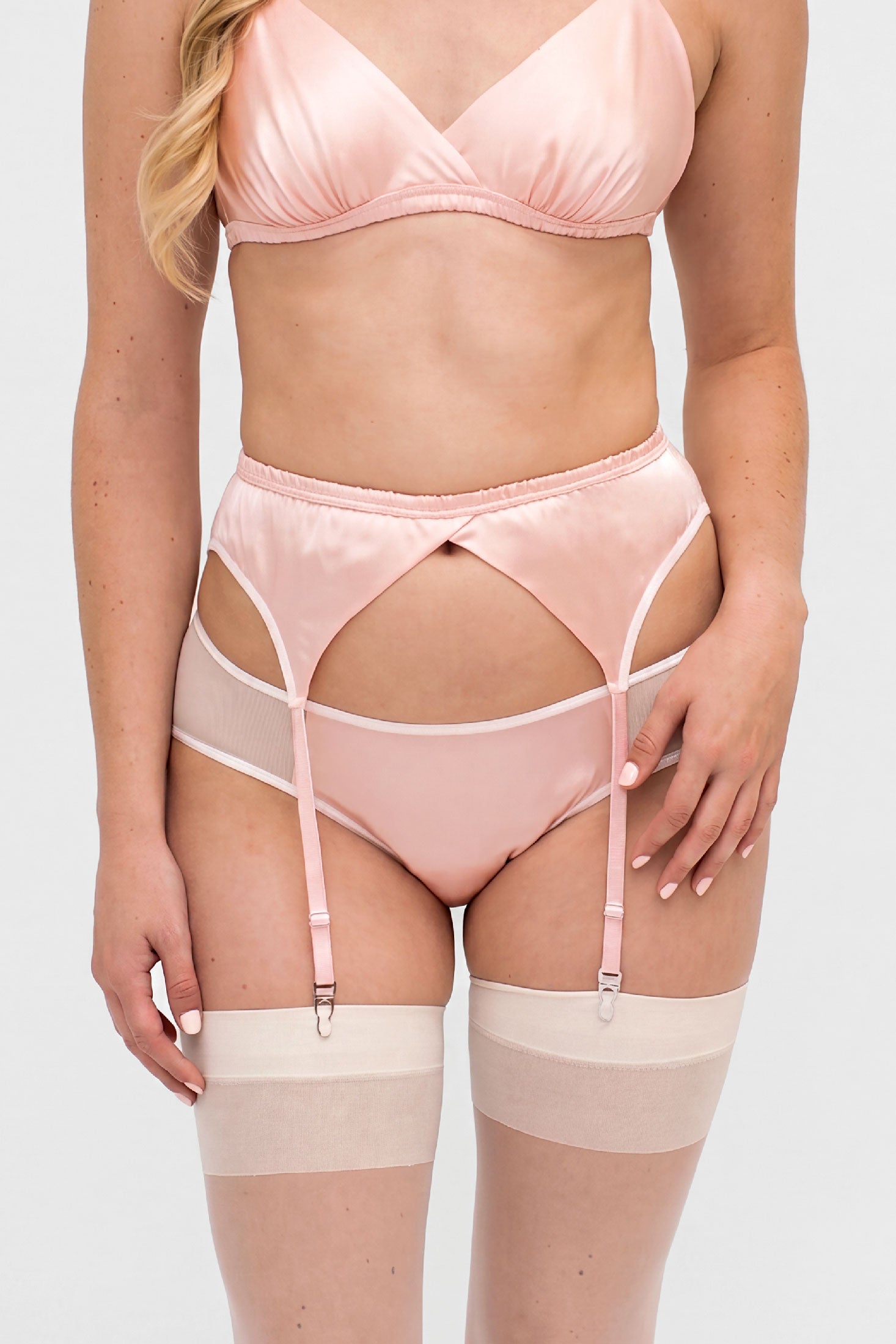 Pink silk lingerie set with vintage style suspender belt and white stockings