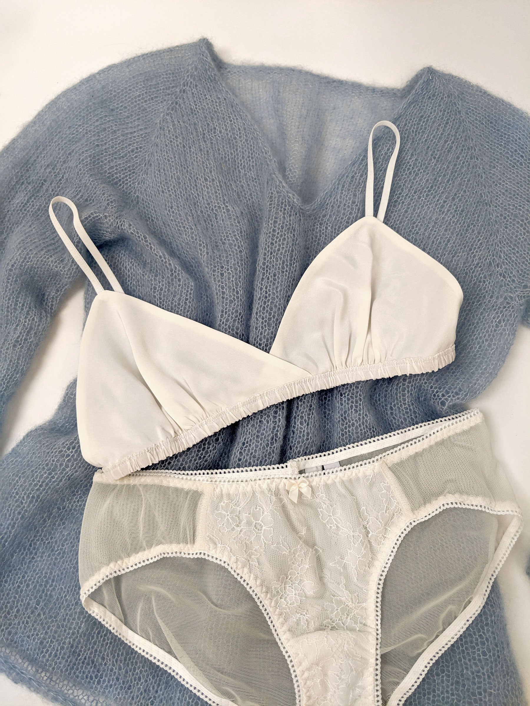 100% silk bralette with white lace underwear and a blue handknit jumper