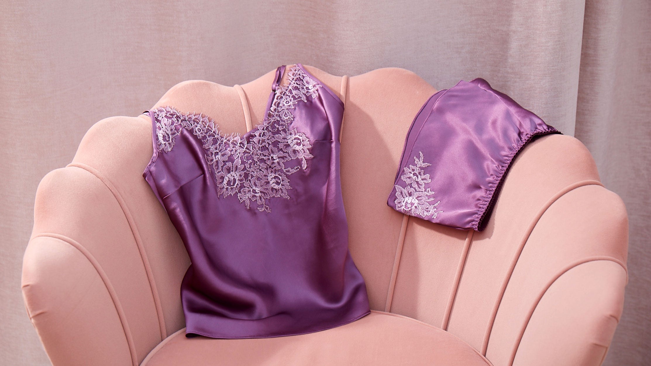Couture loungewear set in purple silk with floral french lace applique, draped over a scalloped pink velvet settee