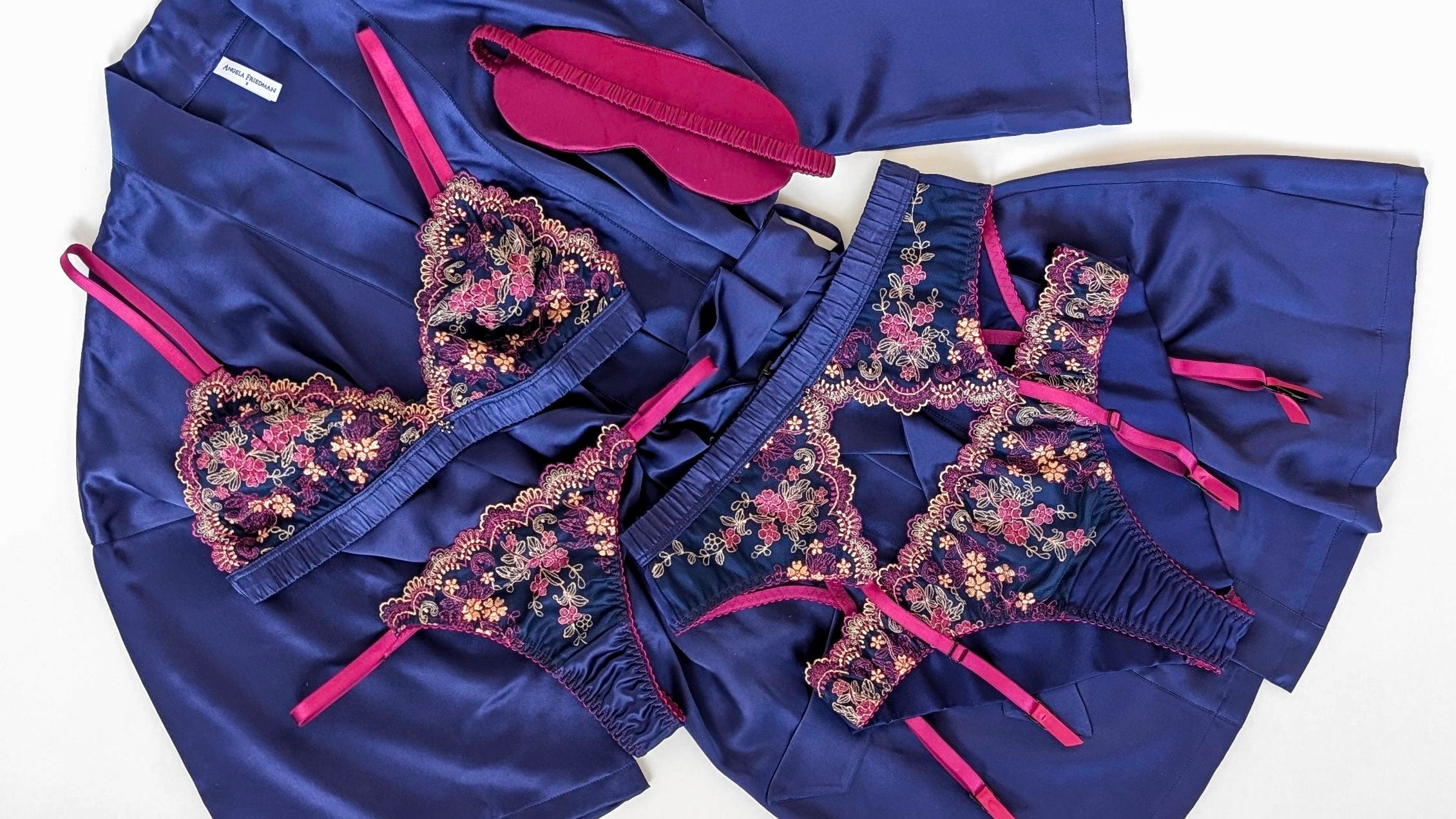 Vintage inspired lingerie set with a blue silk garter belt and suspender clips