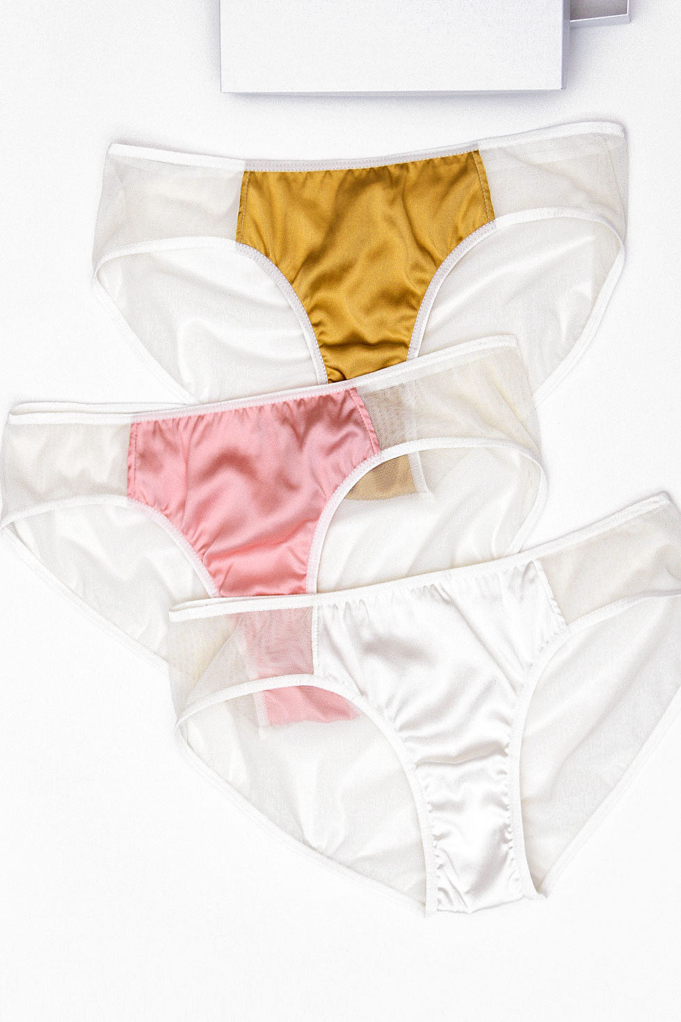 3 pairs of women's silk satin underwear, including 1 each of golden yellow, light pink, and off-white mesh.