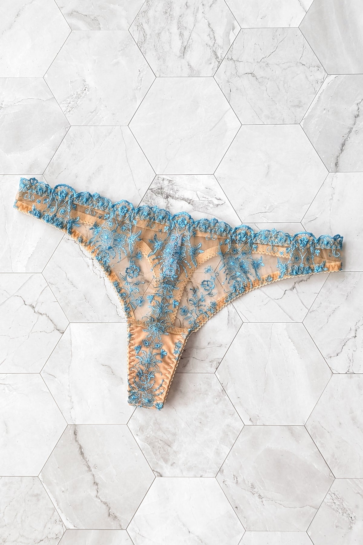 Designer lace panties in a traditional thong cut, handmade in blue embroidered tulle with soft stretch elastic edges