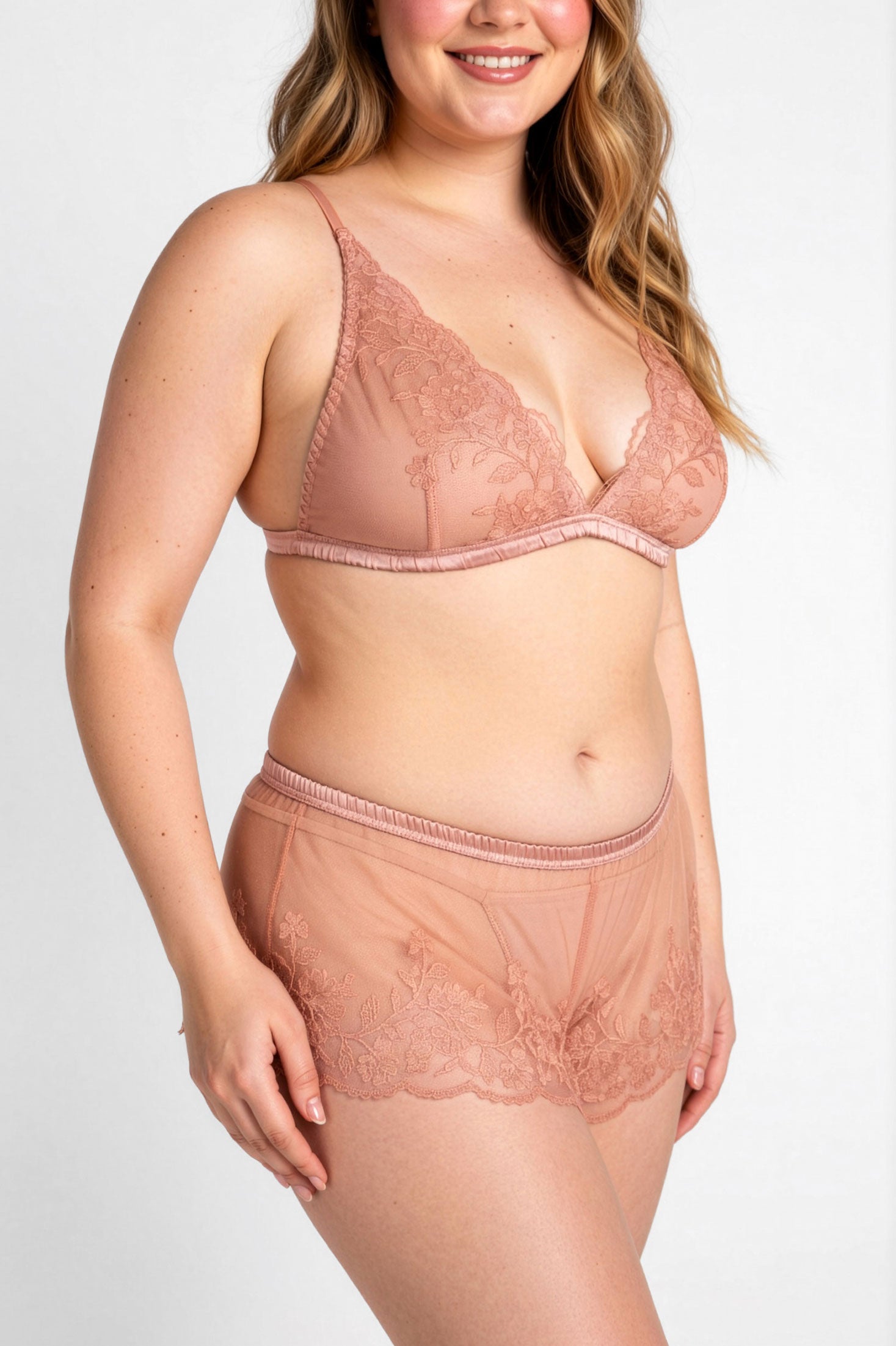 Blush pink embroidered french knickers and wireless bralette on a plus sized model