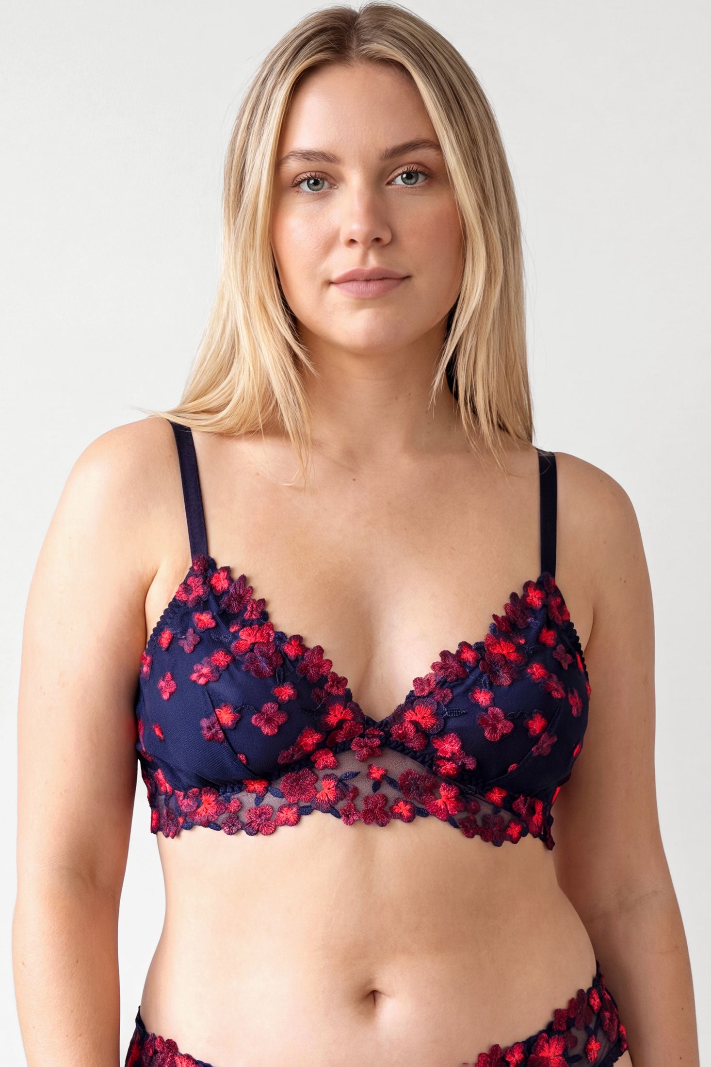 Lydia bralette in navy and neon orange with black-light reactive embroidered flowers overlay