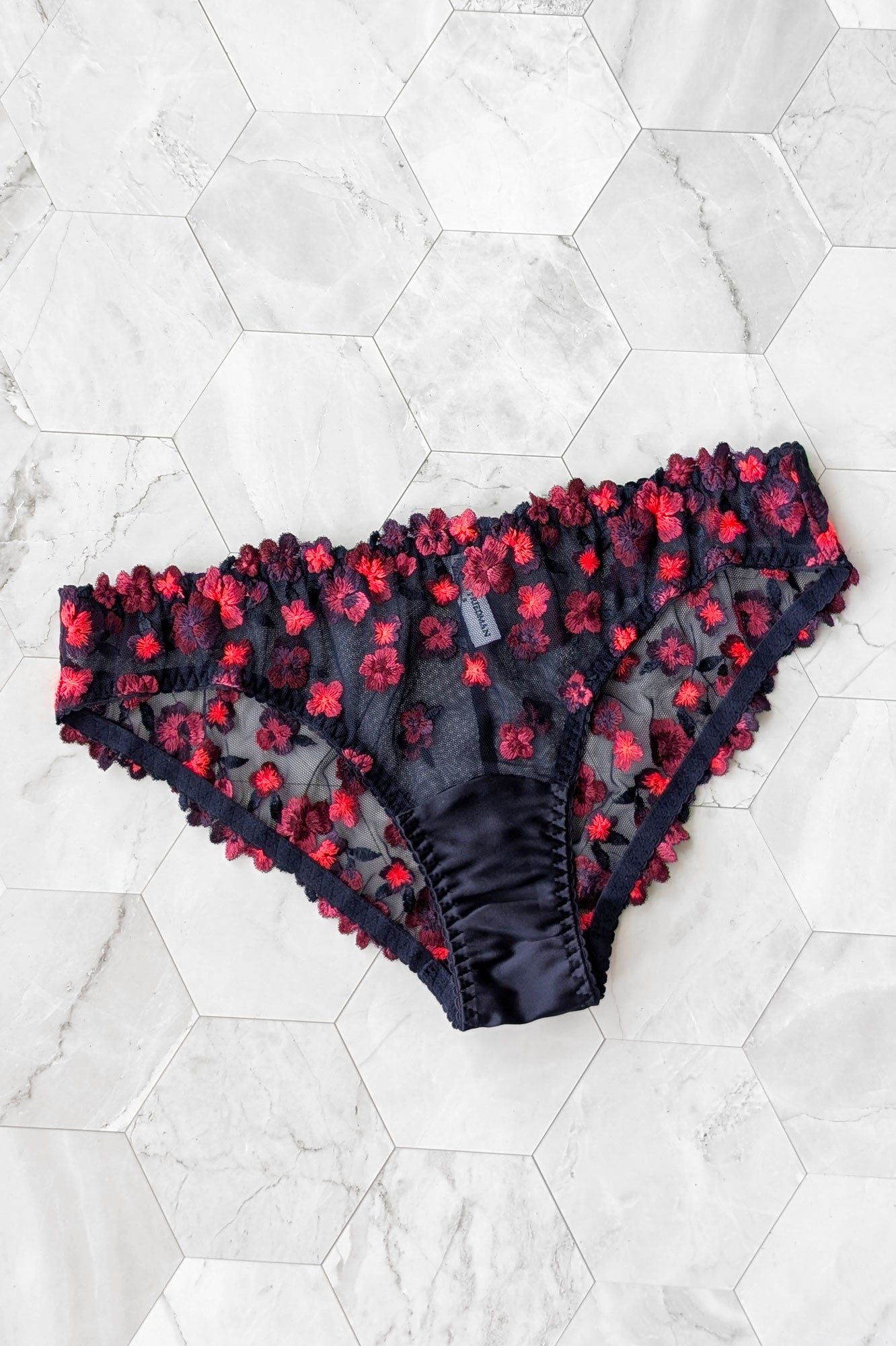 Black light reactive underwear for women with red and orange floral embroidered mesh and real silk satin lining
