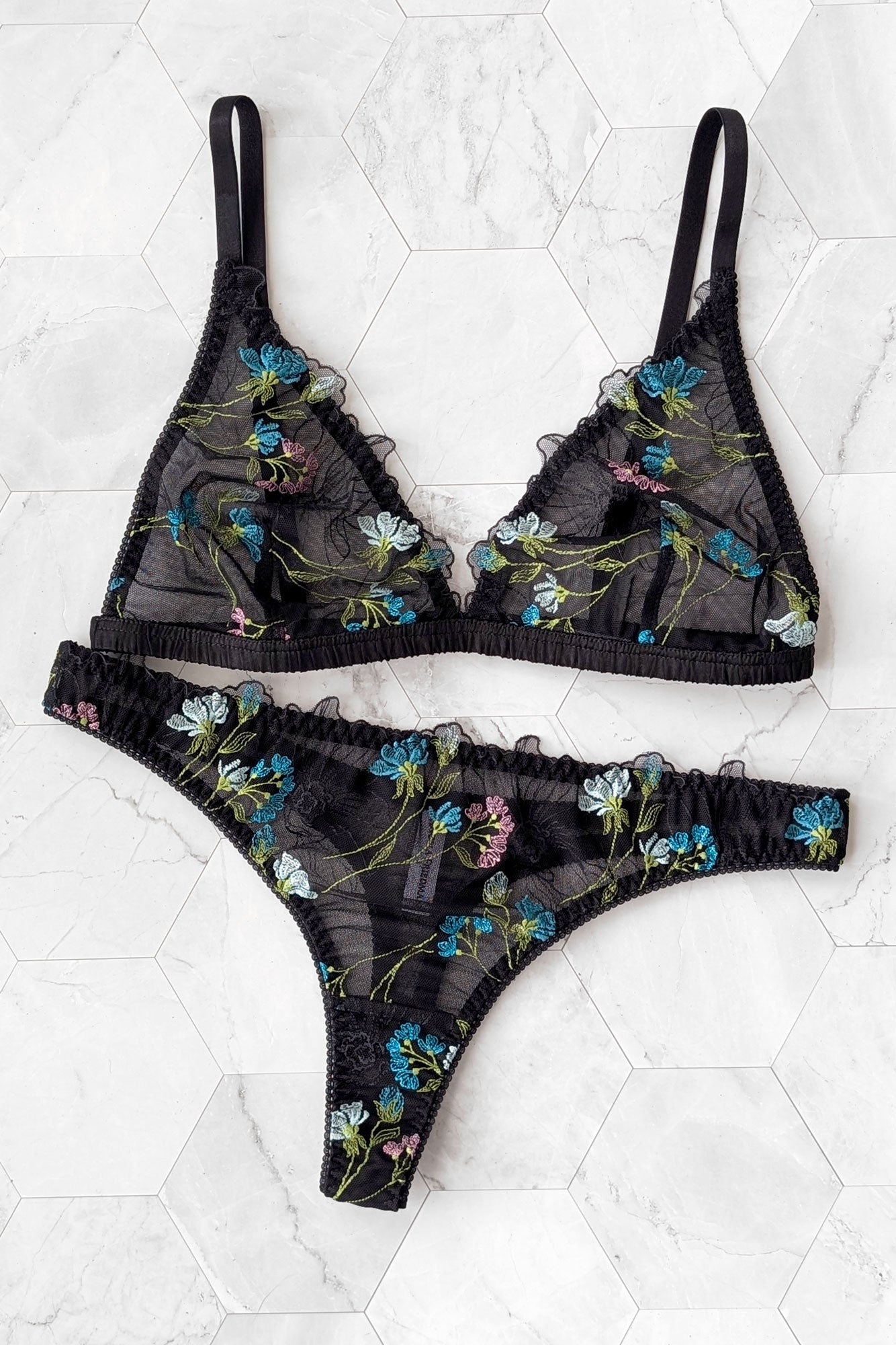 Designer floral lingerie set with multicolor embroidery overlaid on sheer black mesh