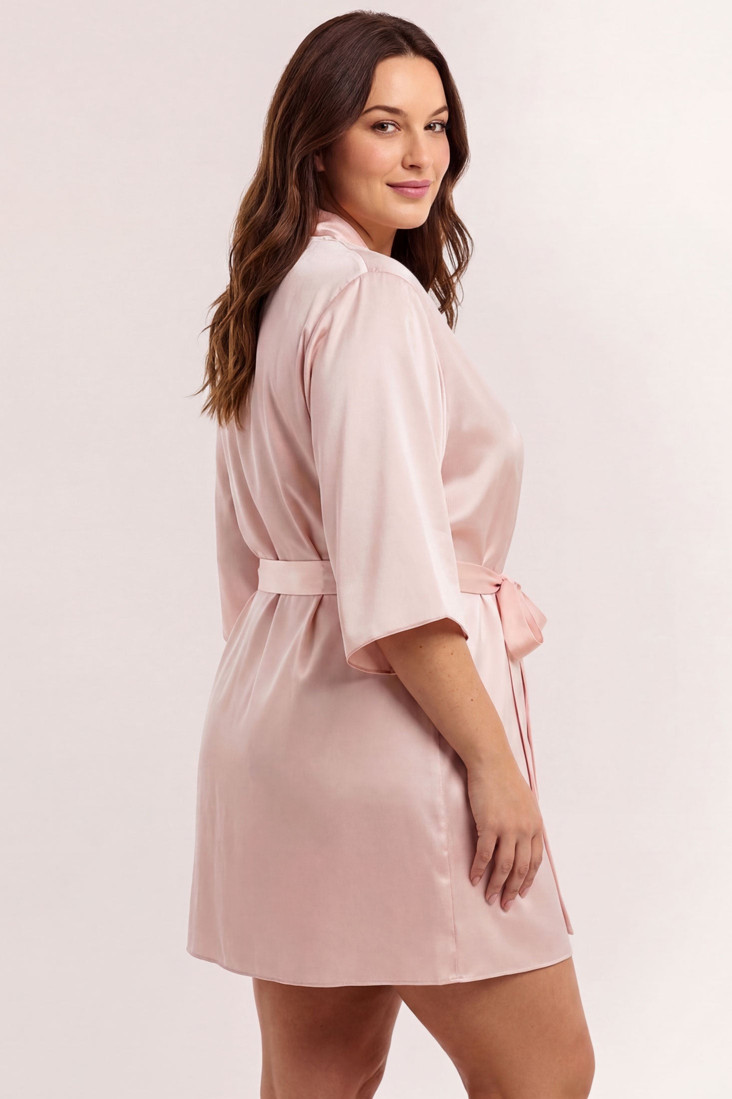 Woman wearing a pink silk satin robe