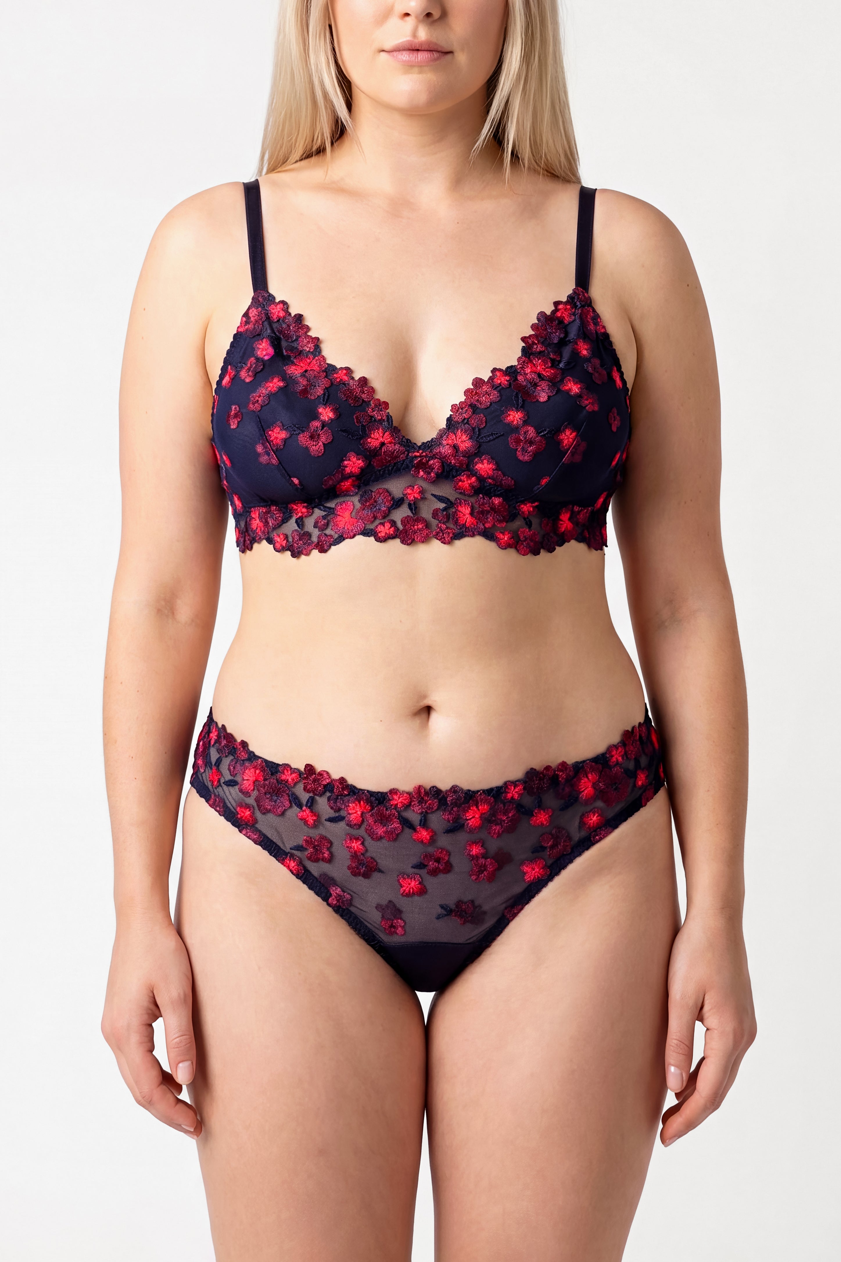 Woman wearing a navy blue and red floral lingerie set with silk linings