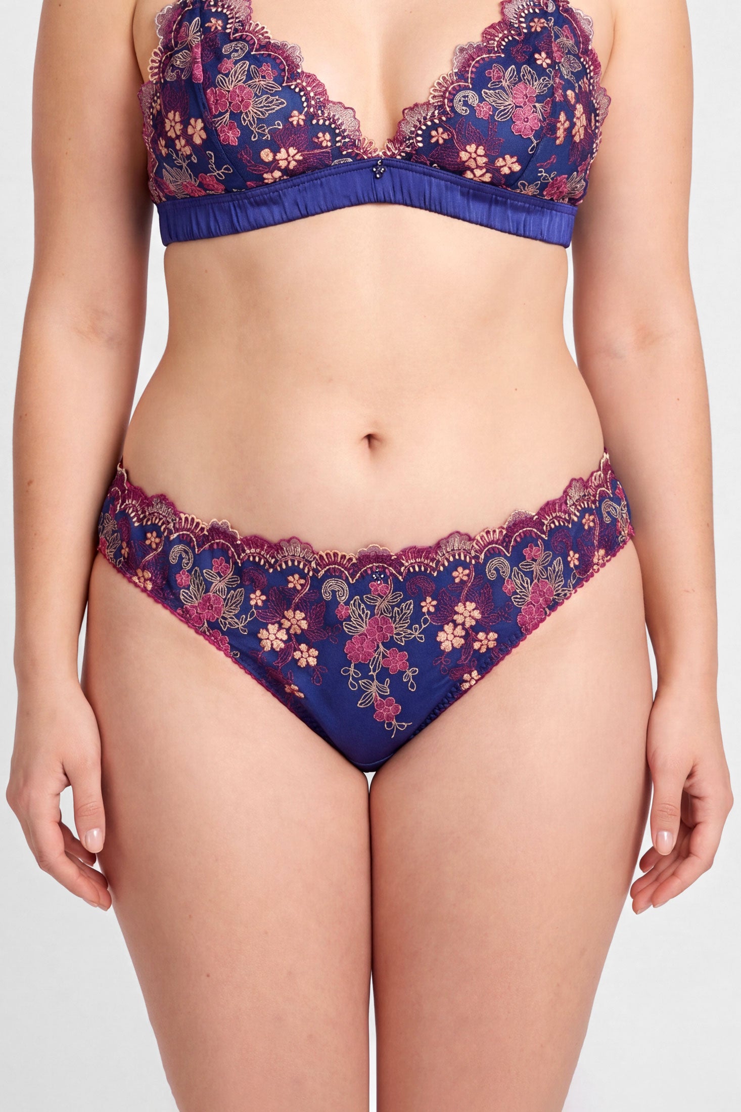 Marina blue silk underwear with pink embroidered overlays, scallop edge detailing, and a cheeky tanga cut back