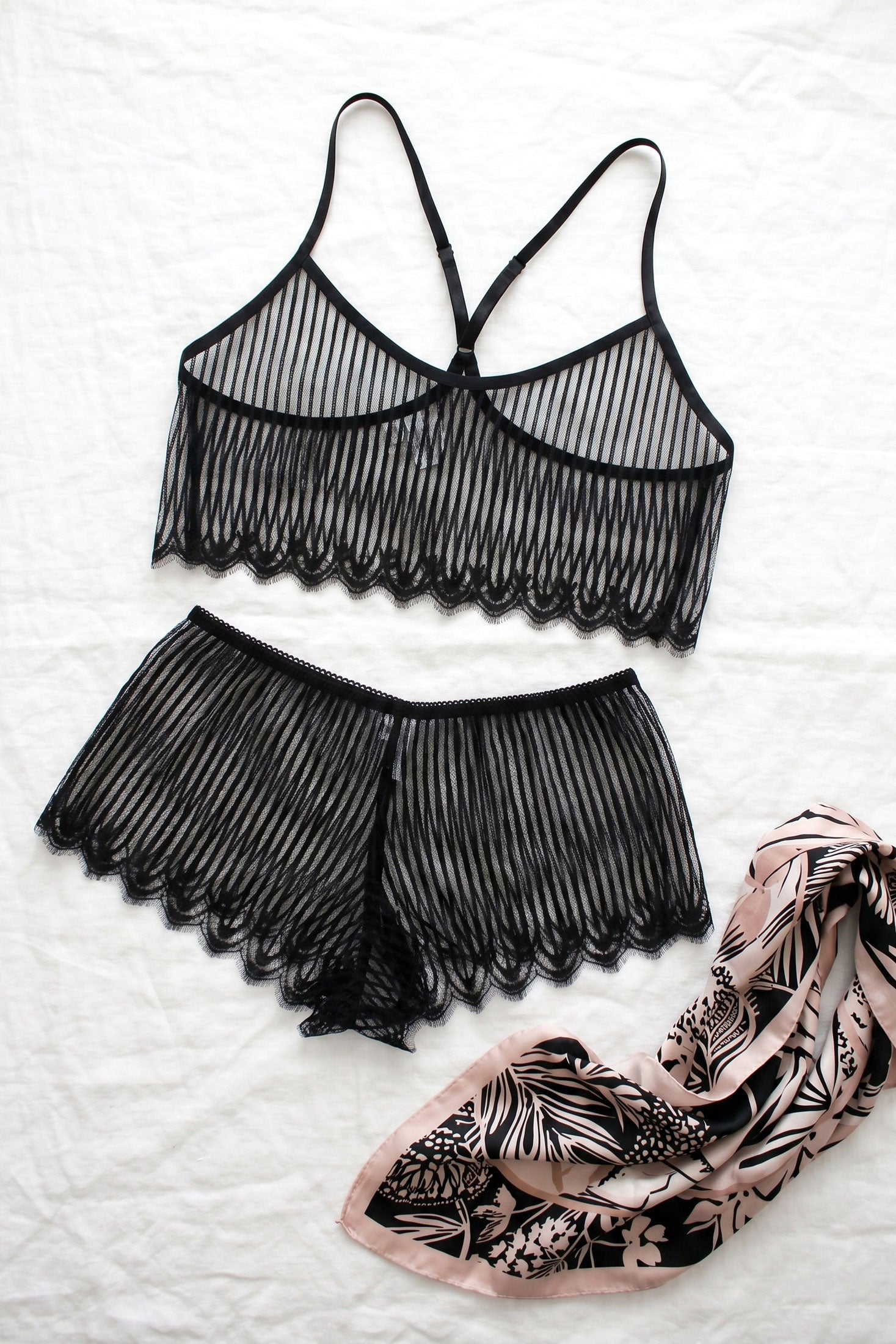 Black lace lingerie set with a floral patterned scarf by luxury loungewear brand Angela Friedman