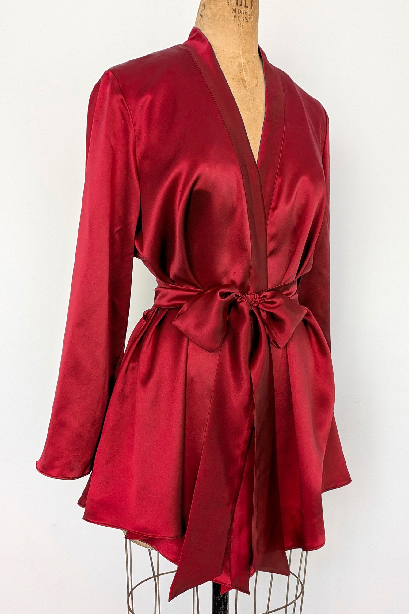 Red silk satin robe with a handkerchief hem and long sleeves