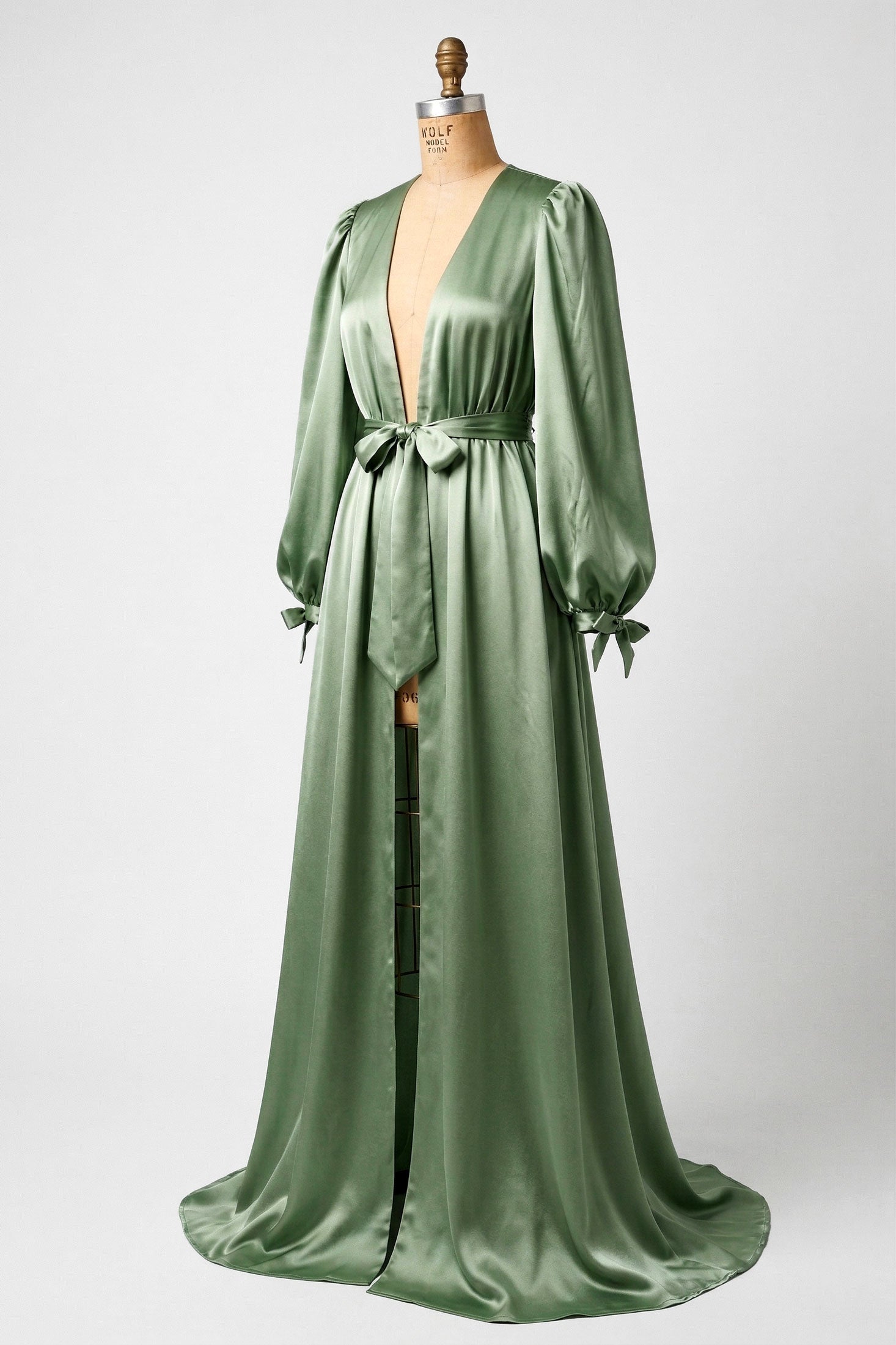 Sage green silk satin robe with bows and a floor length skirt
