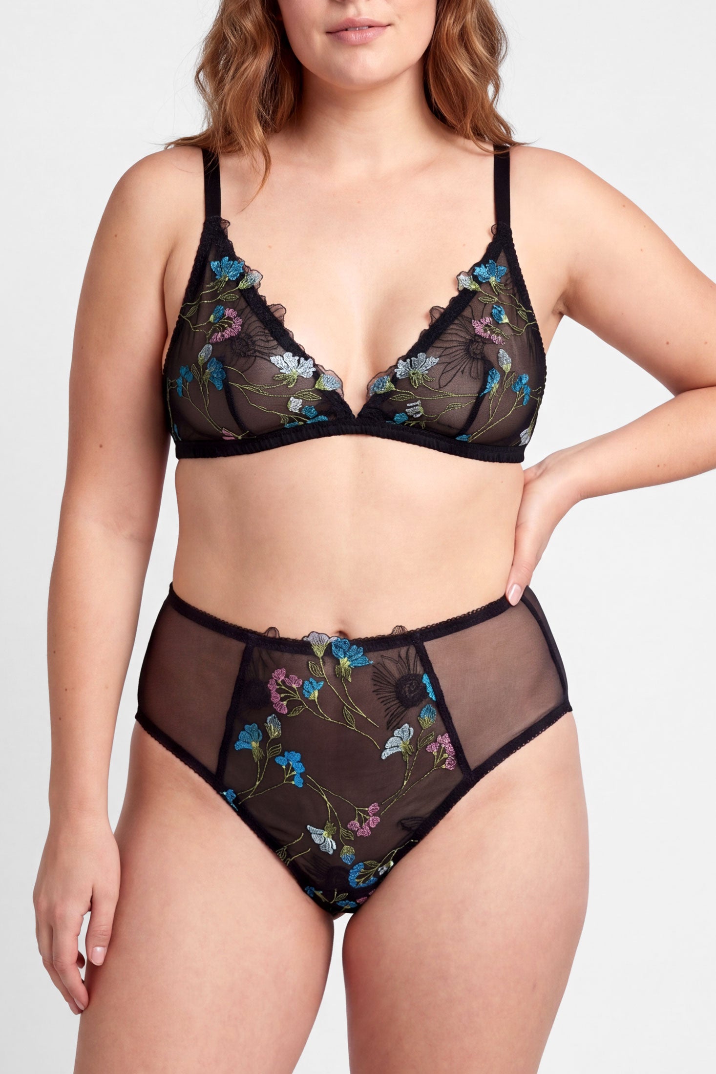 Closeup of a luxury lingerie set in floral embroidery and black mesh with silk trims