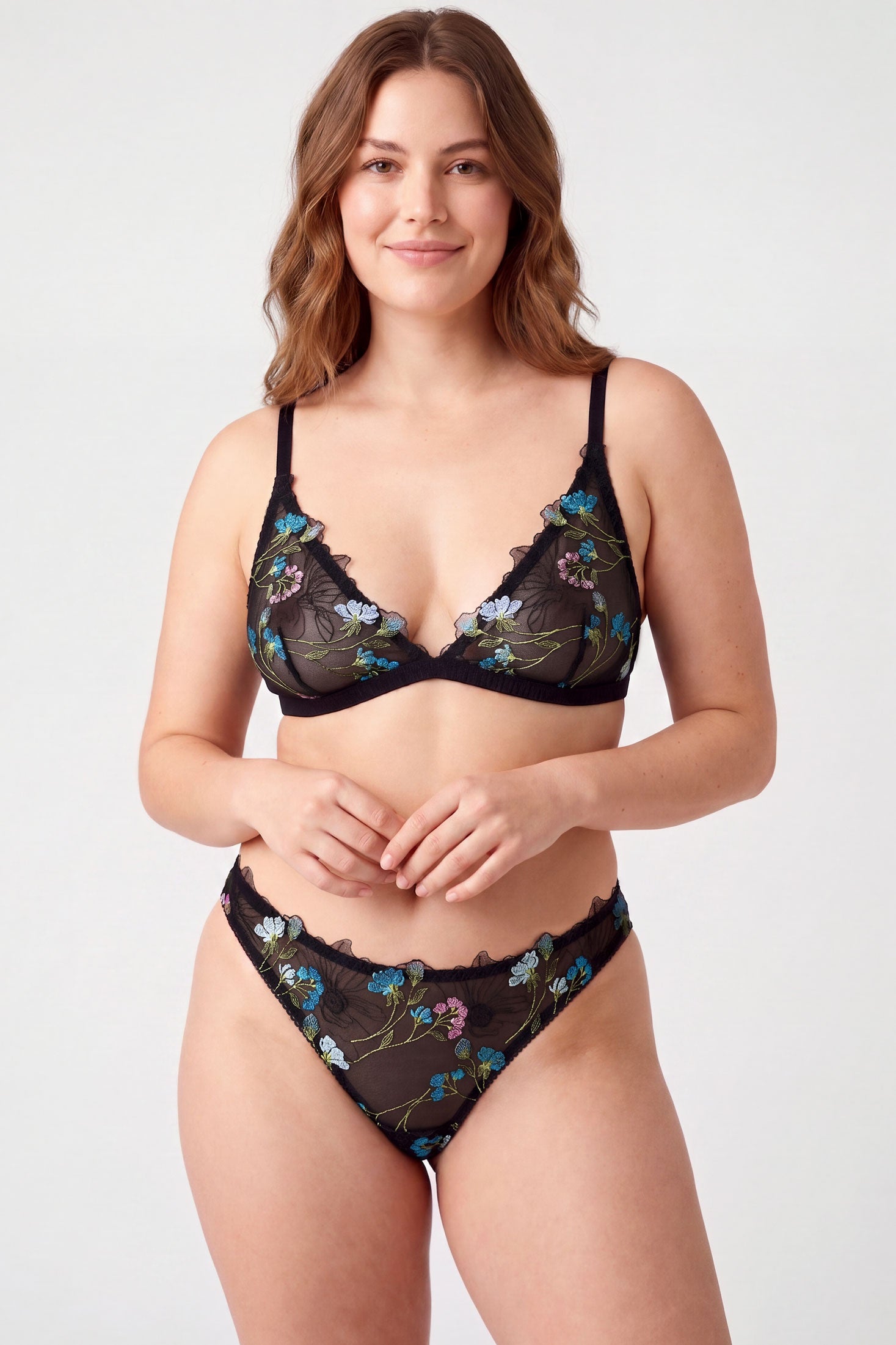 Black mesh bra and thong set with blue, pink, and green embroidery with flowers and vines