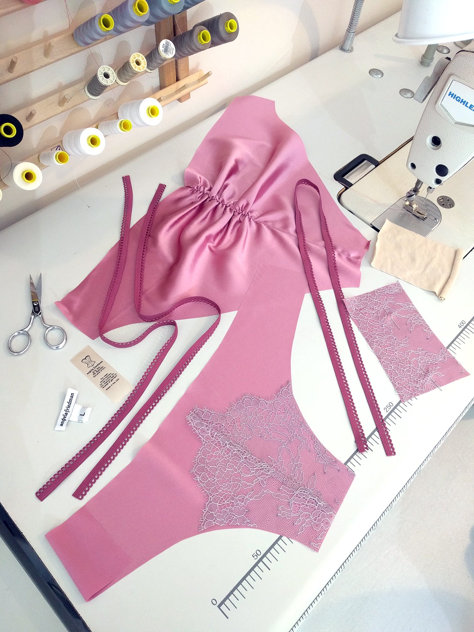 Pink silk lingerie set being sewn in England by Angela Friedman 
