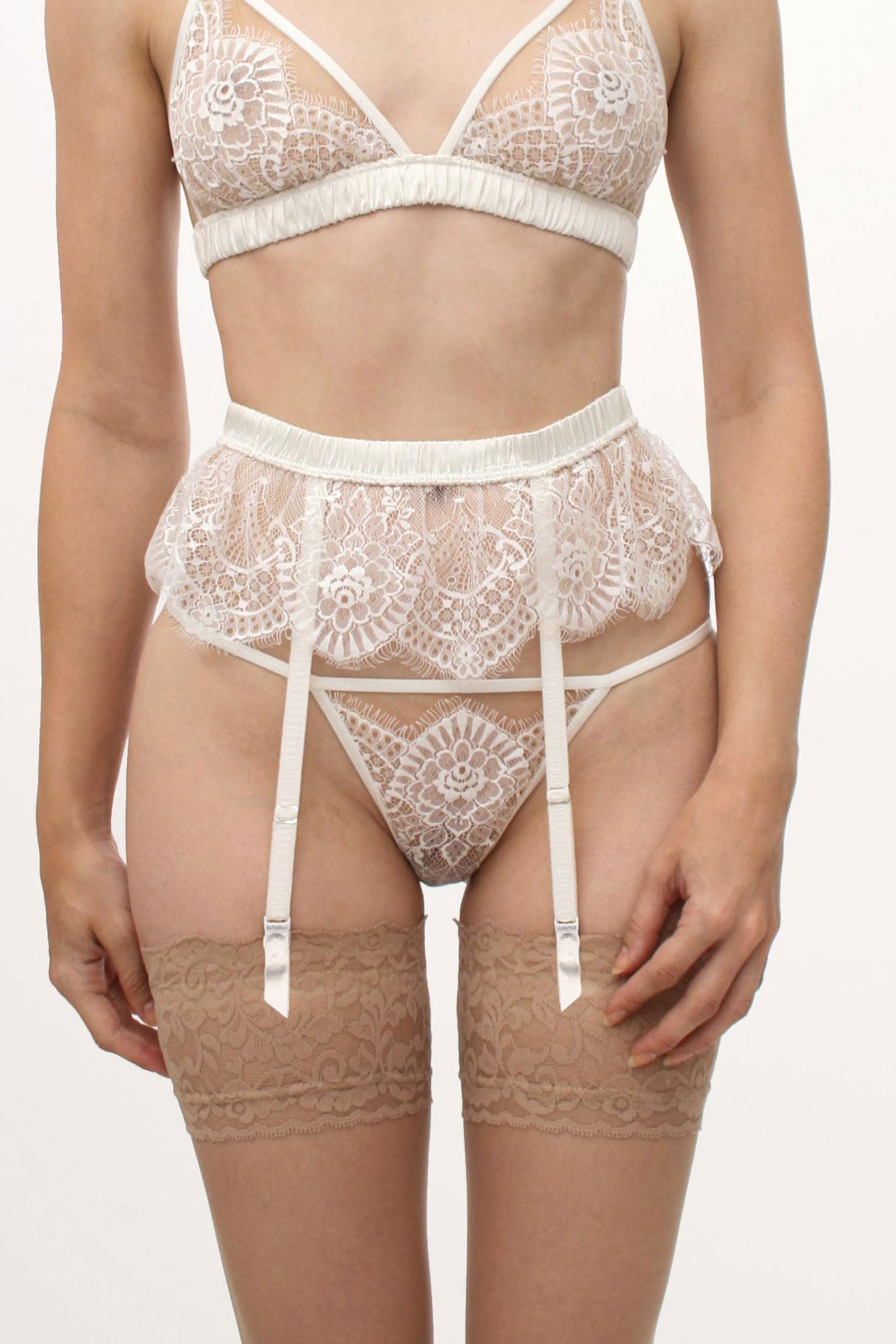 Luxury wedding lingerie set with a white lace suspender belt and thong