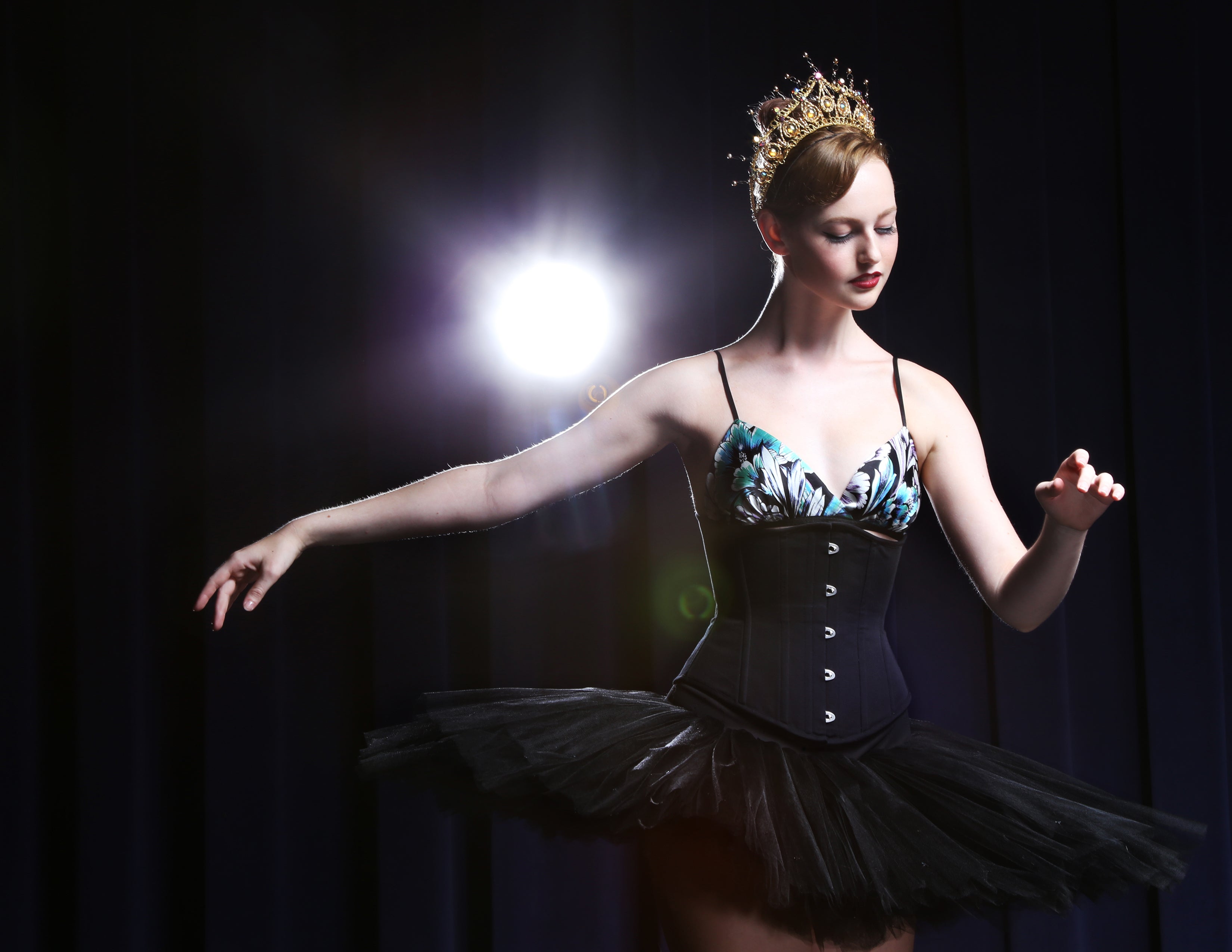 Ballerina wearing a tutu and black underbust corset waist cincher