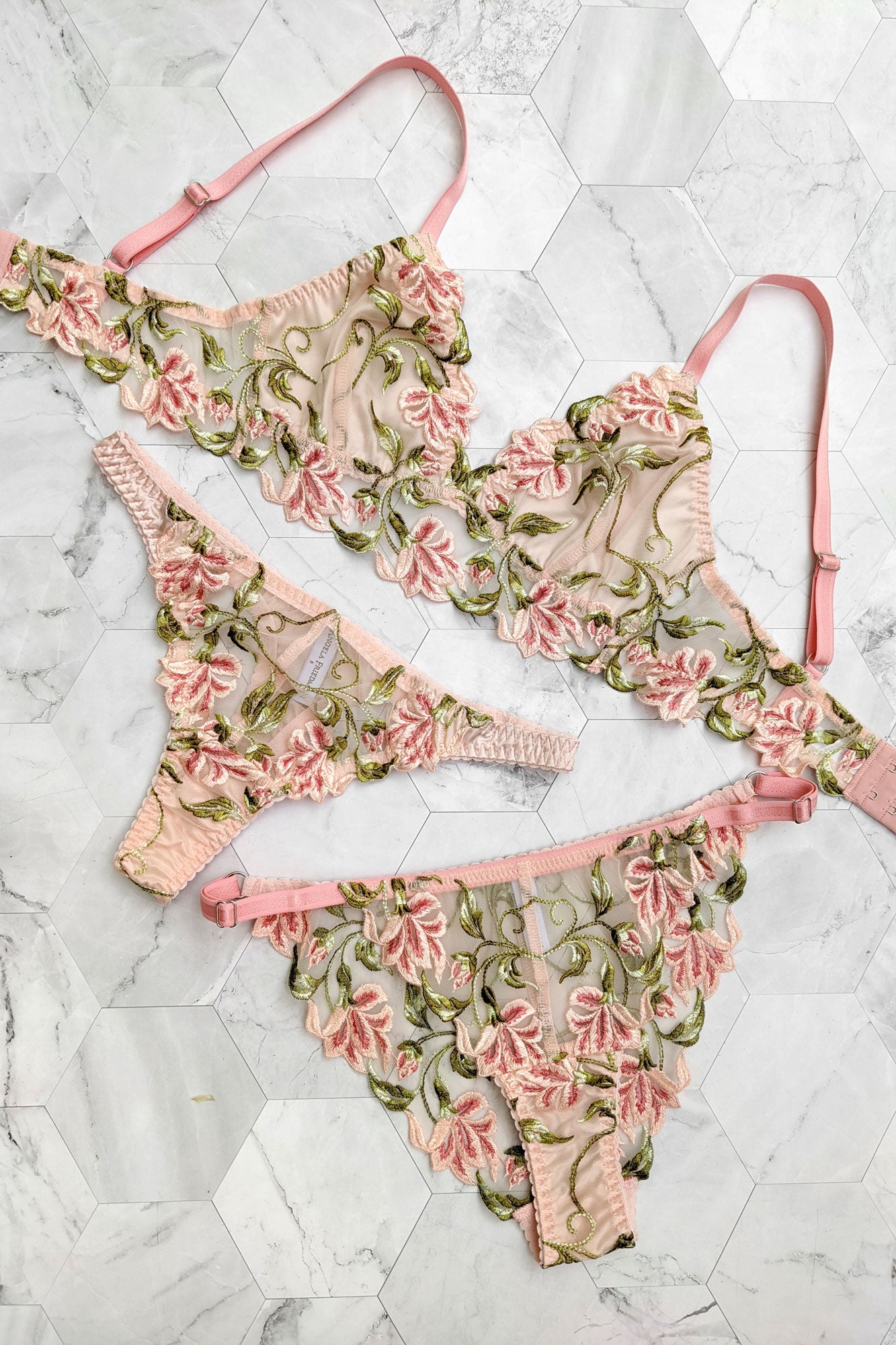Luxury lingerie set with floral embroidery on the silk bra, thong, and panties