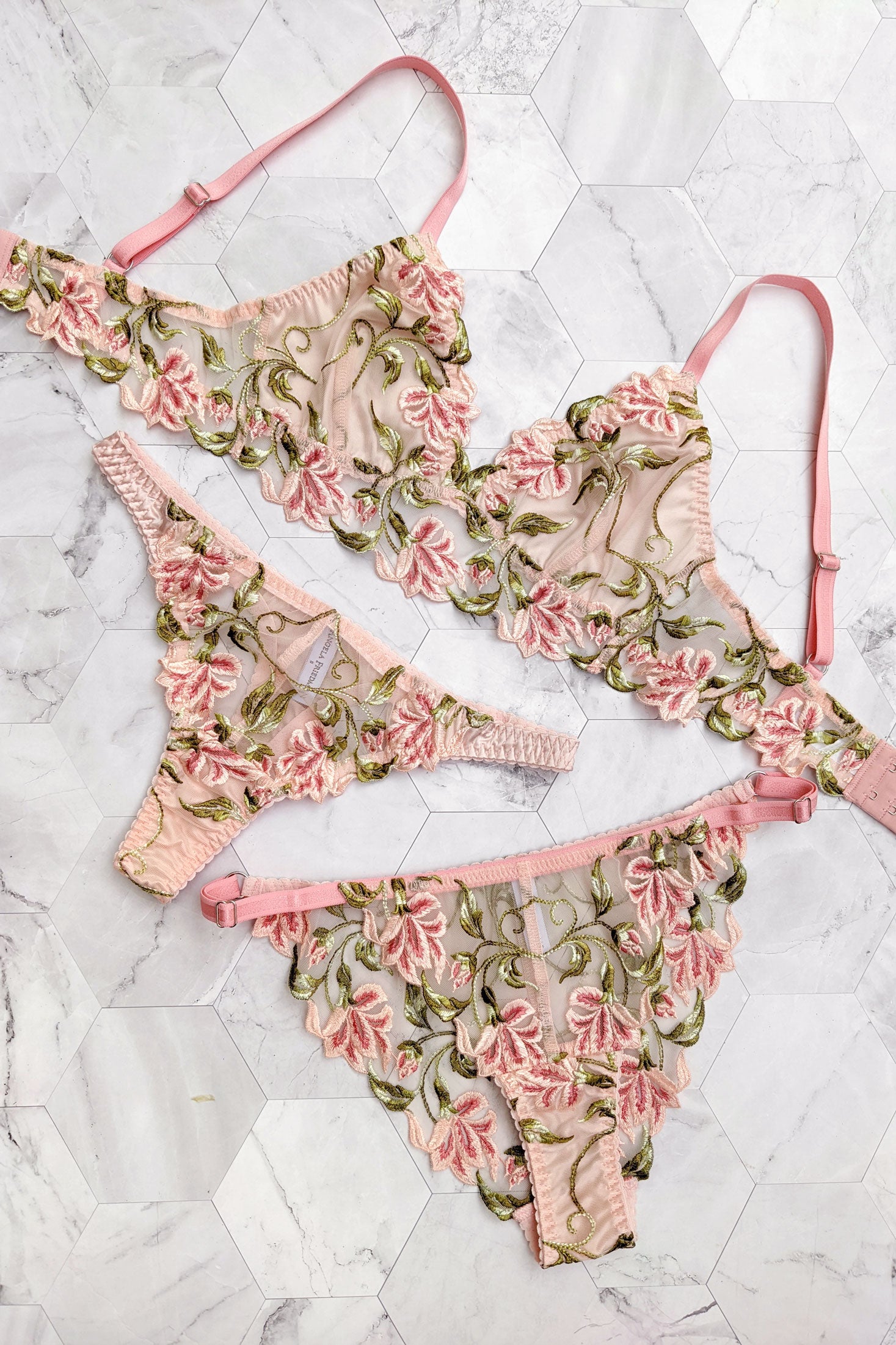 Luxury lingerie set with floral embroidery on the silk bra, thong, and panties